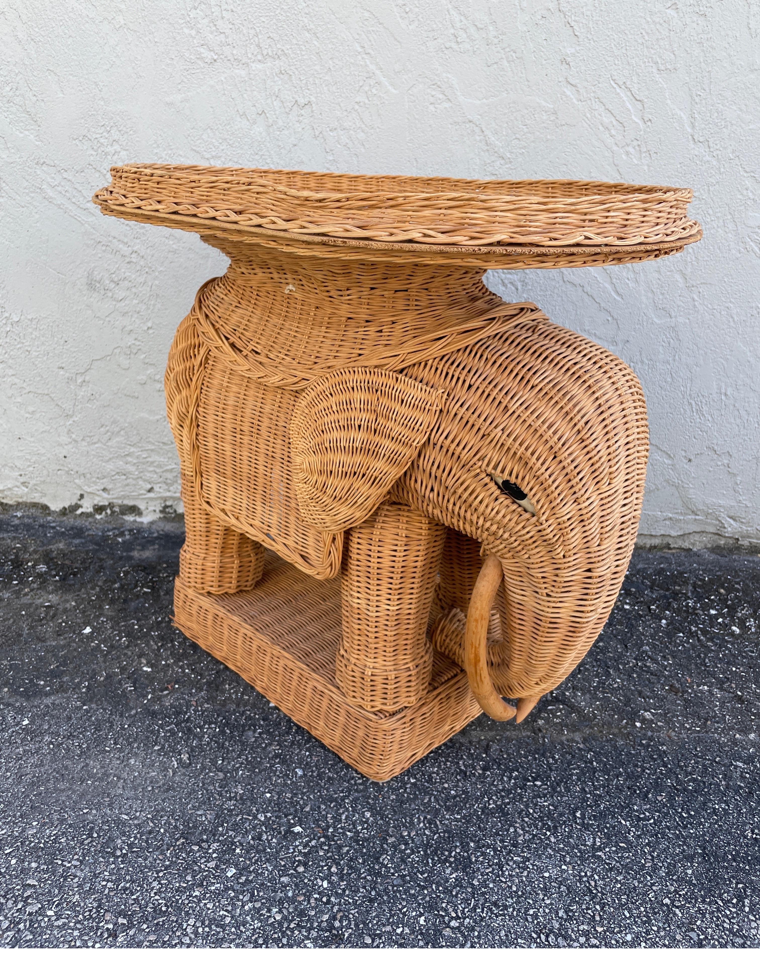 Natural wicker elephant side tray table in the style of Mario Lopez Torres.
