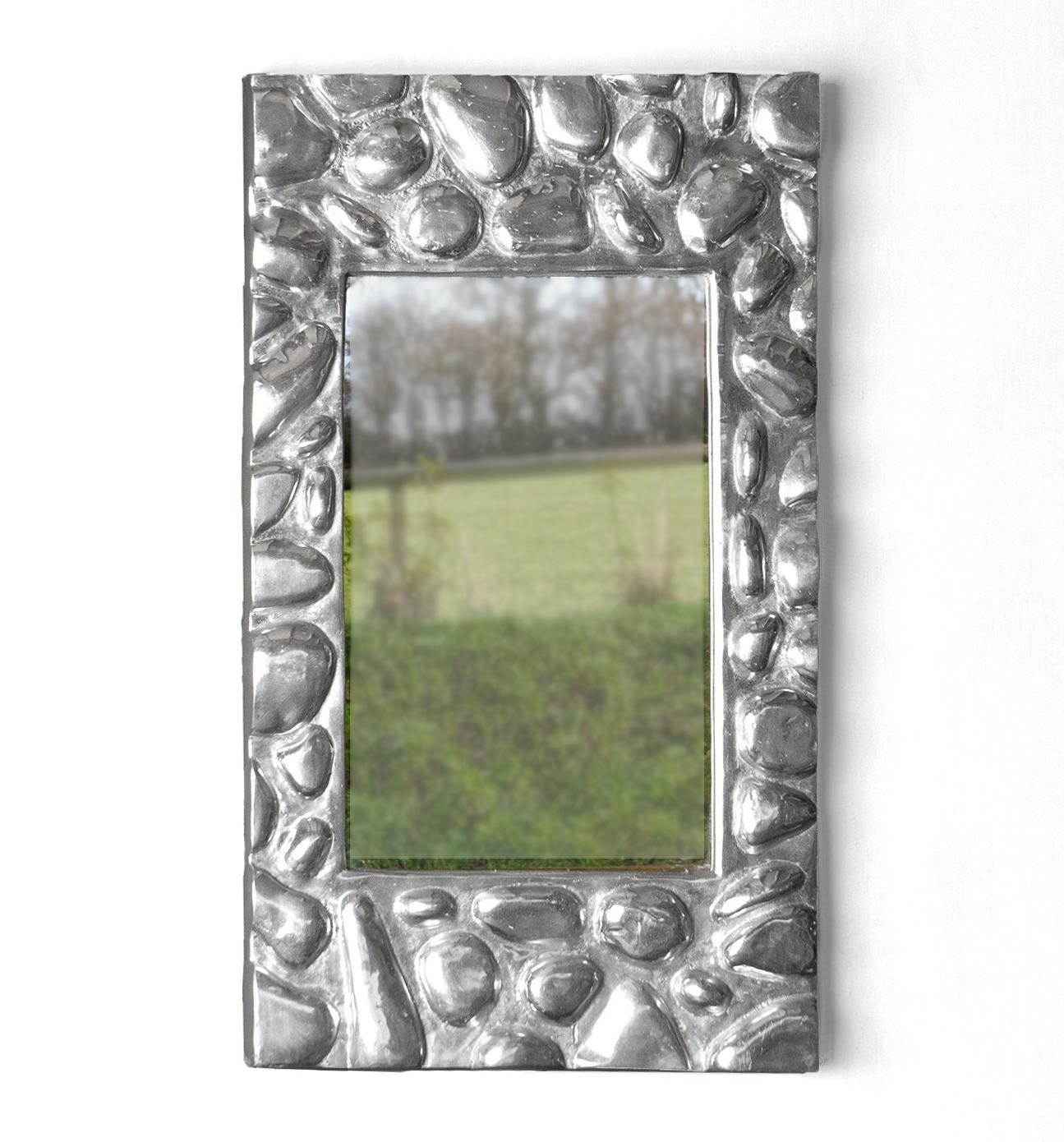 Mid-Century Wall Mirror

Silver frame stylised as pebbles.

Cast from aluminium.

Paper label verso titles the piece ‘Brighton Beach’.

It is in very good vintage condition with wear commensurate with age.

Measuring 67cm high x 39cm wide x 5cm deep.