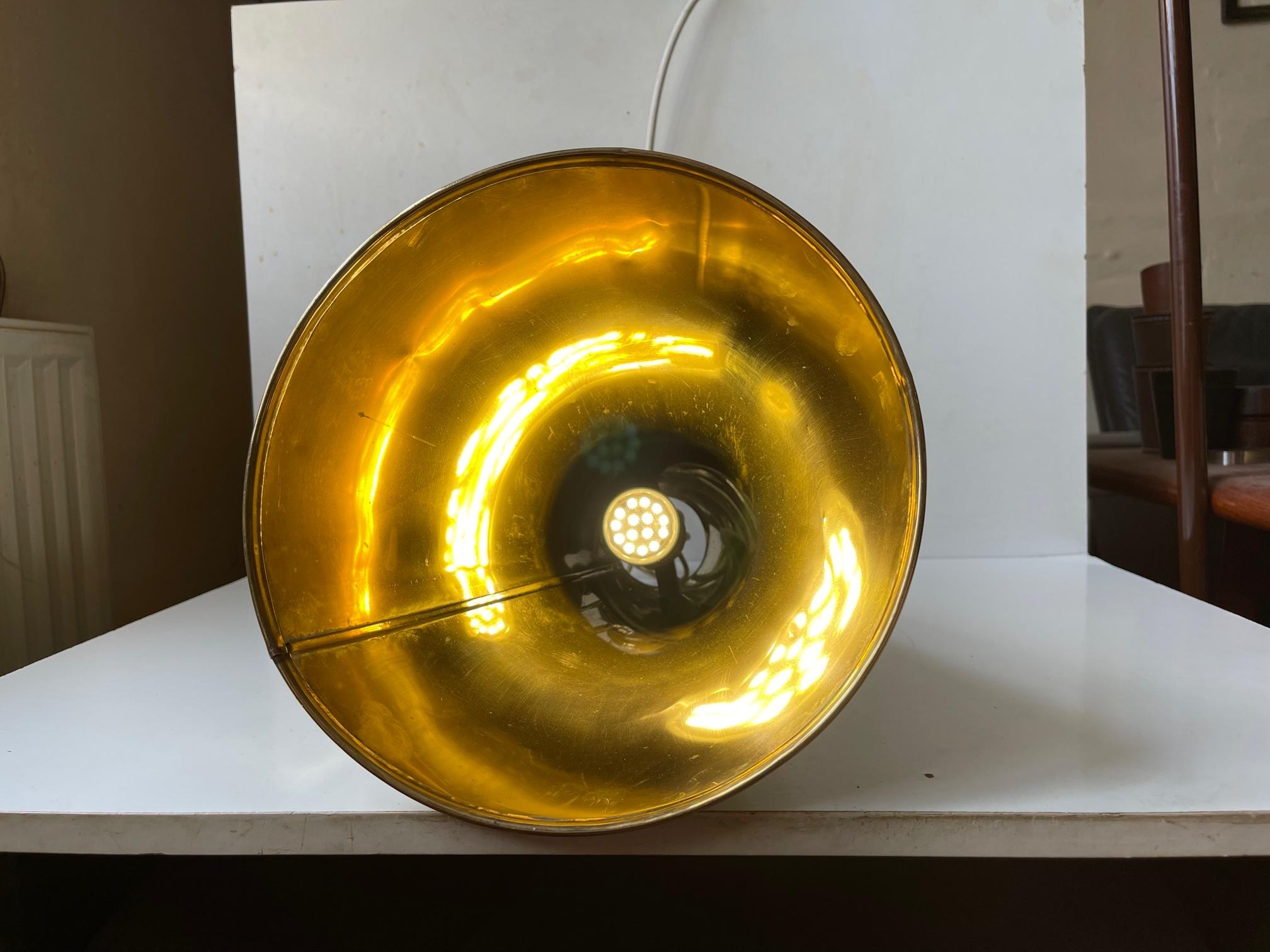 Old stylish yachtsmans megaphone in solid brass converted in to a chain-suspended ceiling lamp during the 1960s or 70s. Probably from Delite in Denmark. Without chain the pendant measures 41 cm in height and has a diameter of 25 cm at the bottom.