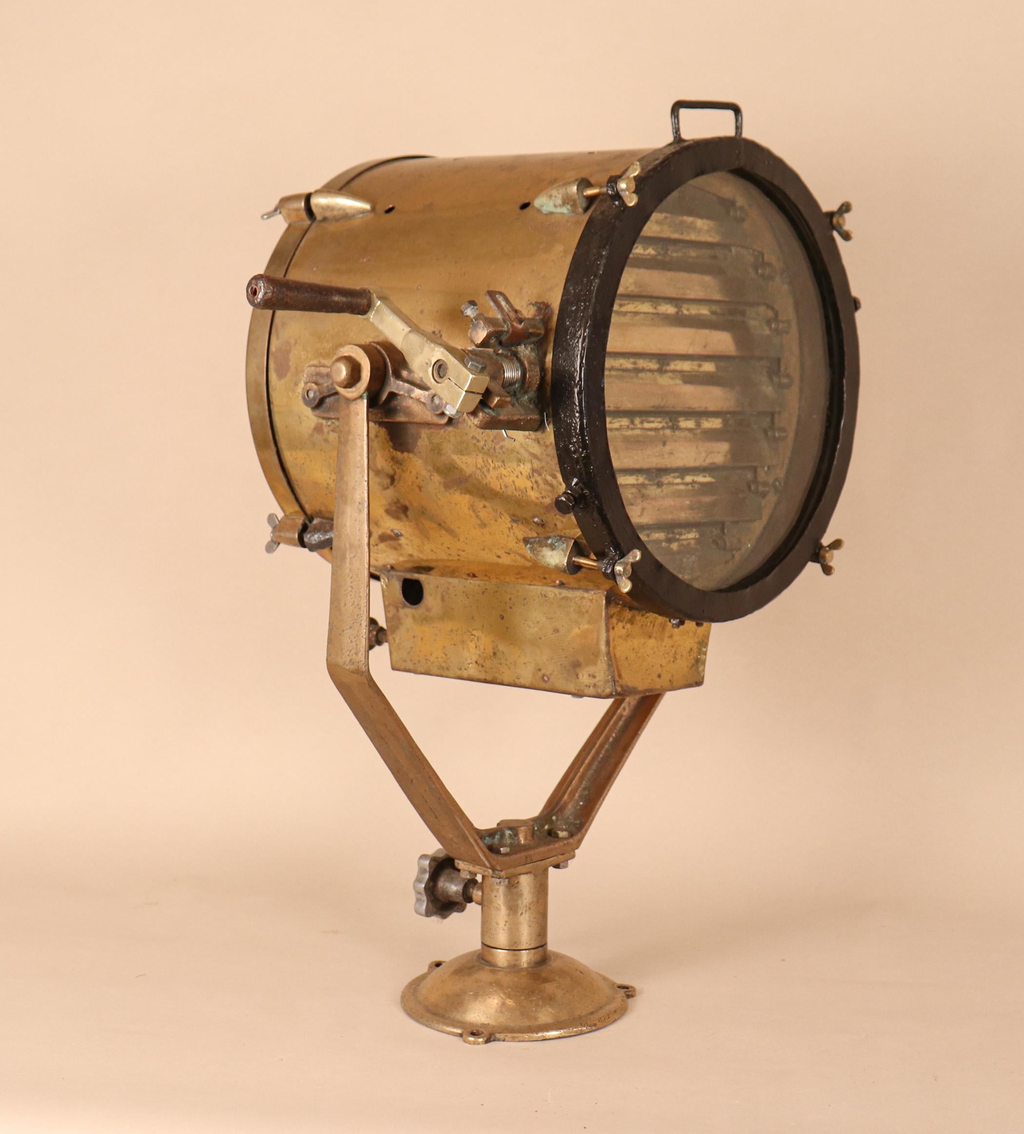 Solid brass daylight signaling lamp with aluminum knobs, salvaged from a Japanese naval vessel and attentively restored. This circa 1940 maritime lantern has a tempered glass lens, working brass signal shutters, nice pivot movement, and all-original