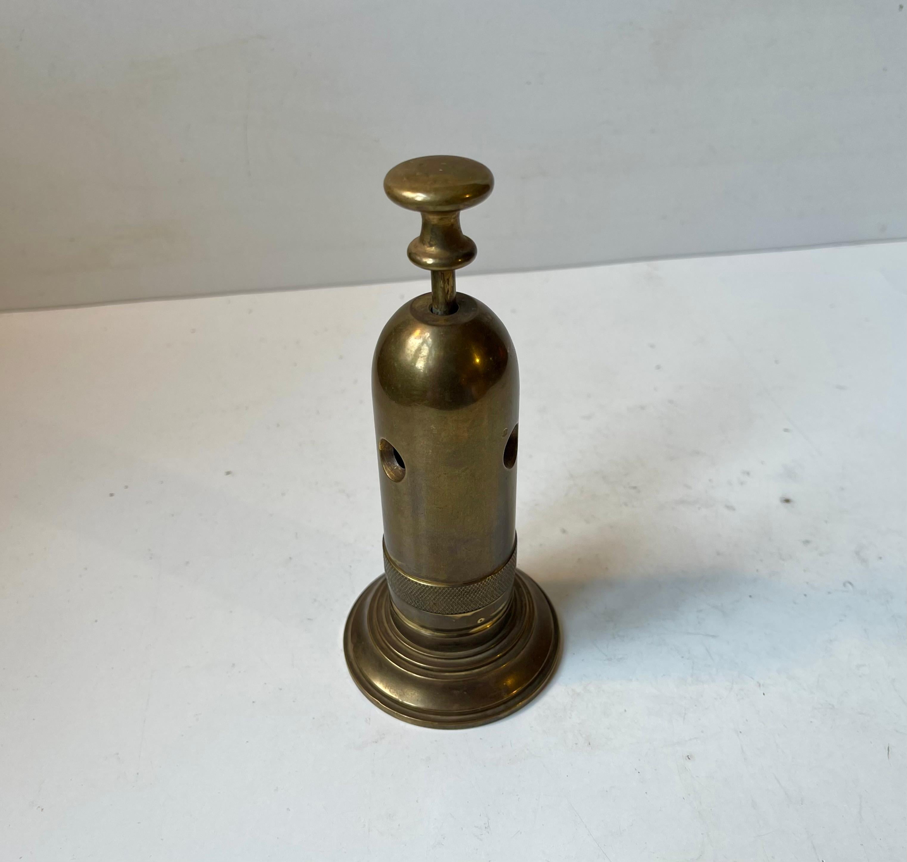 A stationary desk cigar cutter in patinated brass. It was made in Scandinavia during the 1930s from the top of an old ships steam whistle. Beautiful repurposed Art Deco design. Built as a tank it is obviously fully functional. Steady and heavy in