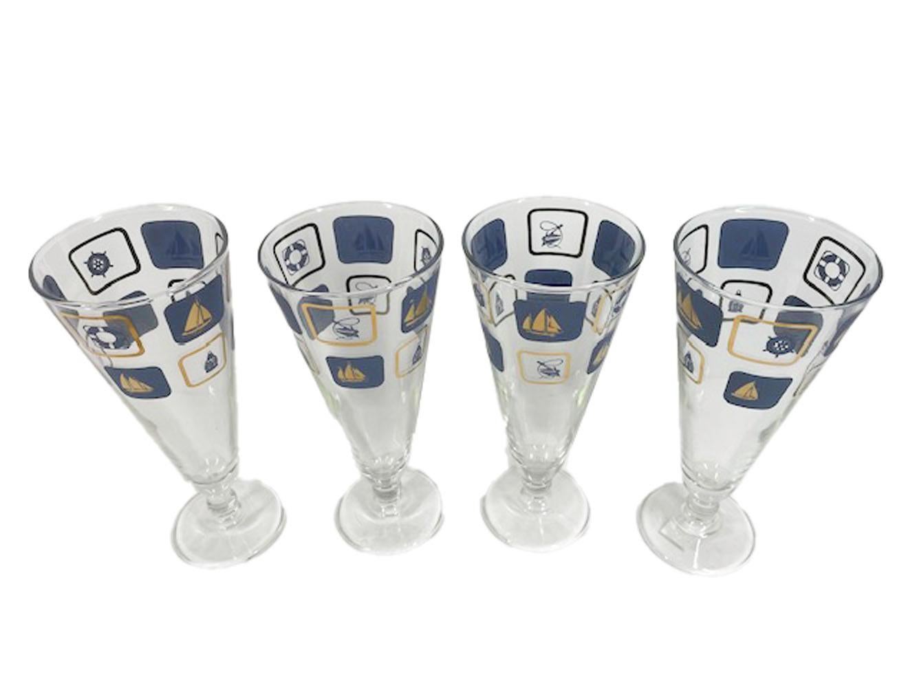 Vintage nautical themed pilsner glasses with two rows of rectangles, each containing a sailboat or nautical object, in blue enamel and 22 karat gold.