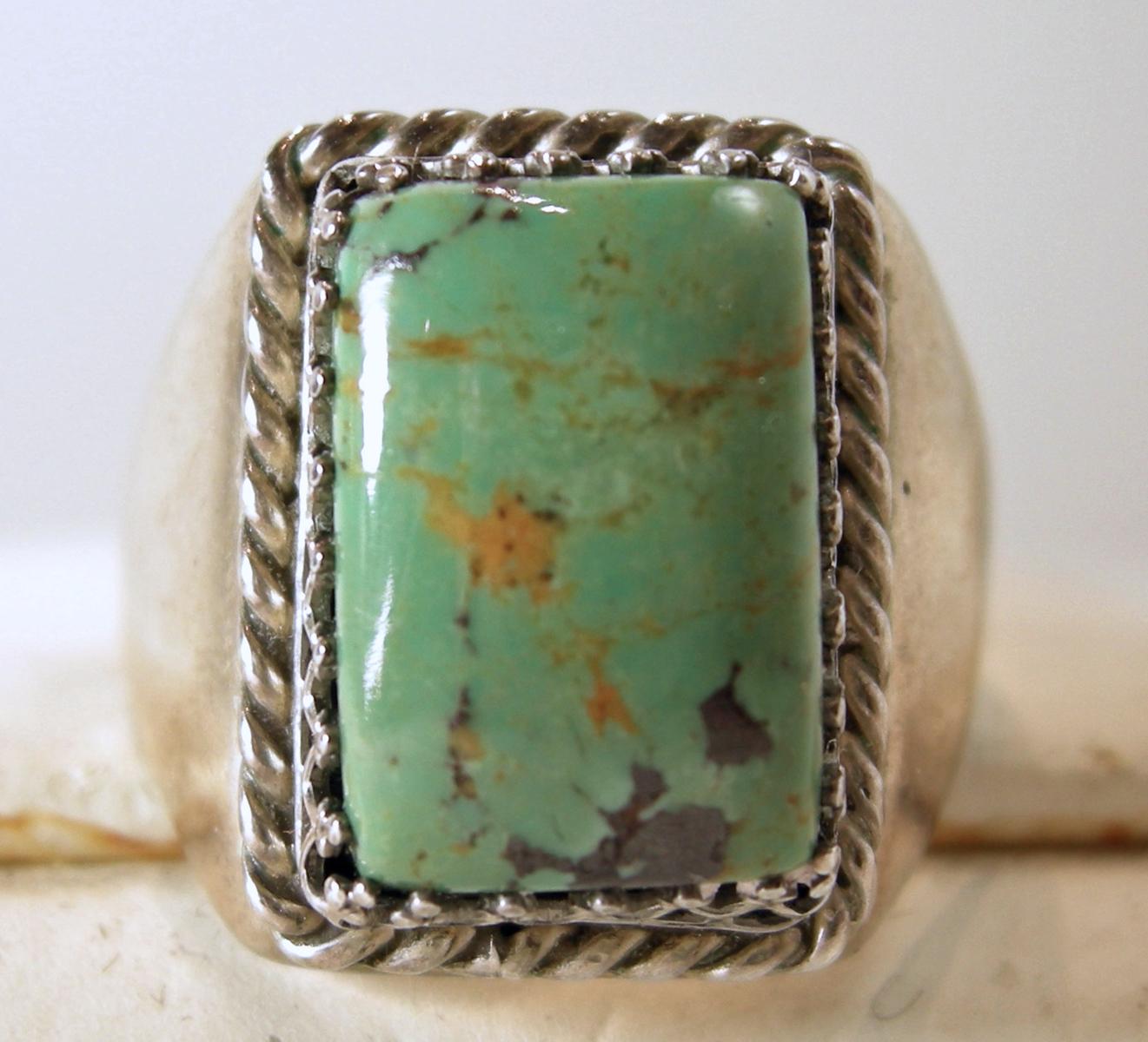 This vintage Navajo American Indian ring has a green turquoise with a sterling silver ribbed border.  It is a size 11-1/2 and measures 3/4