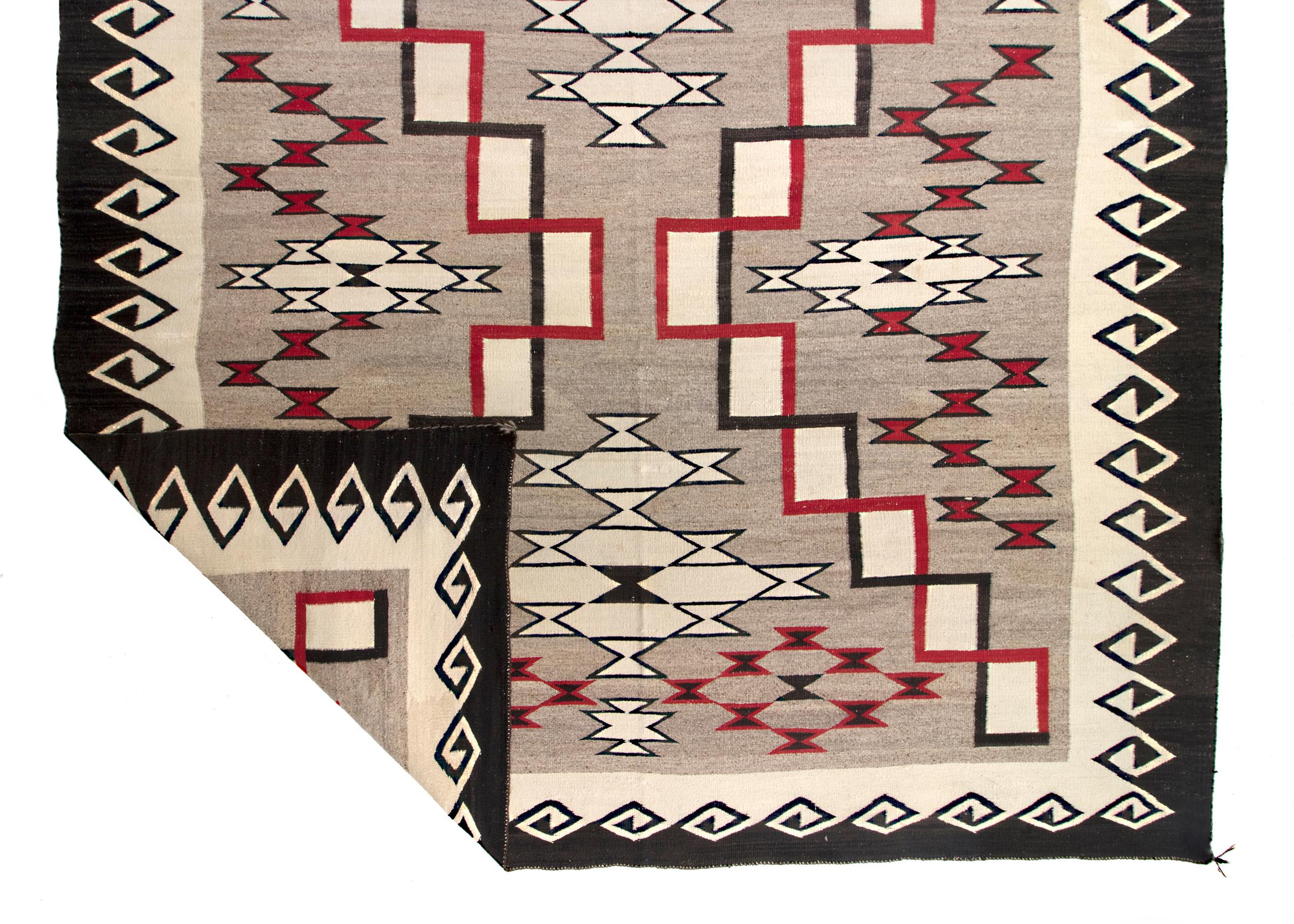 Vintage Southwestern Navajo wool area rug woven at the Ganado Trading Post (founded by John Lorenzo Hubbell at Ganado, Arizona, in 1876), circa 1900-1925. Woven of native handspun wool in natural fleece colors of gray, ivory/white and brown/black