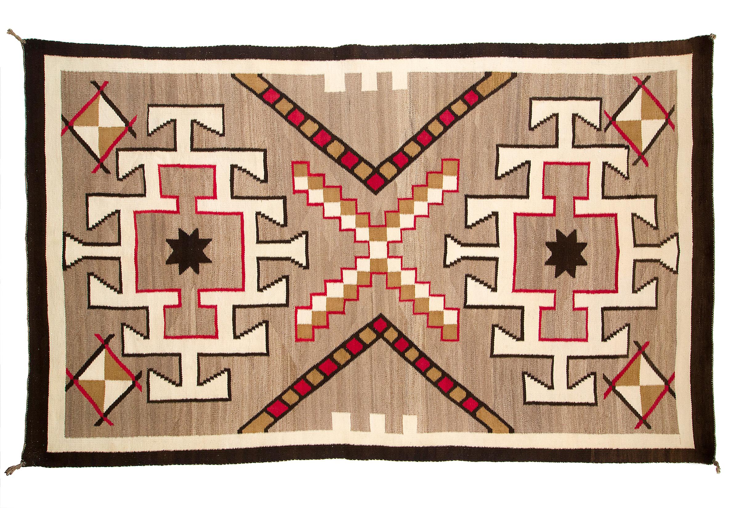 Vintage Navajo rug, circa 1930s, Trading Post era, woven of native hand-spun wool in natural fleece colors of brown/tan with a geometric pattern in white/ivory, black/brown and aniline-dyed red with stylized star. This weaving is well suited for use