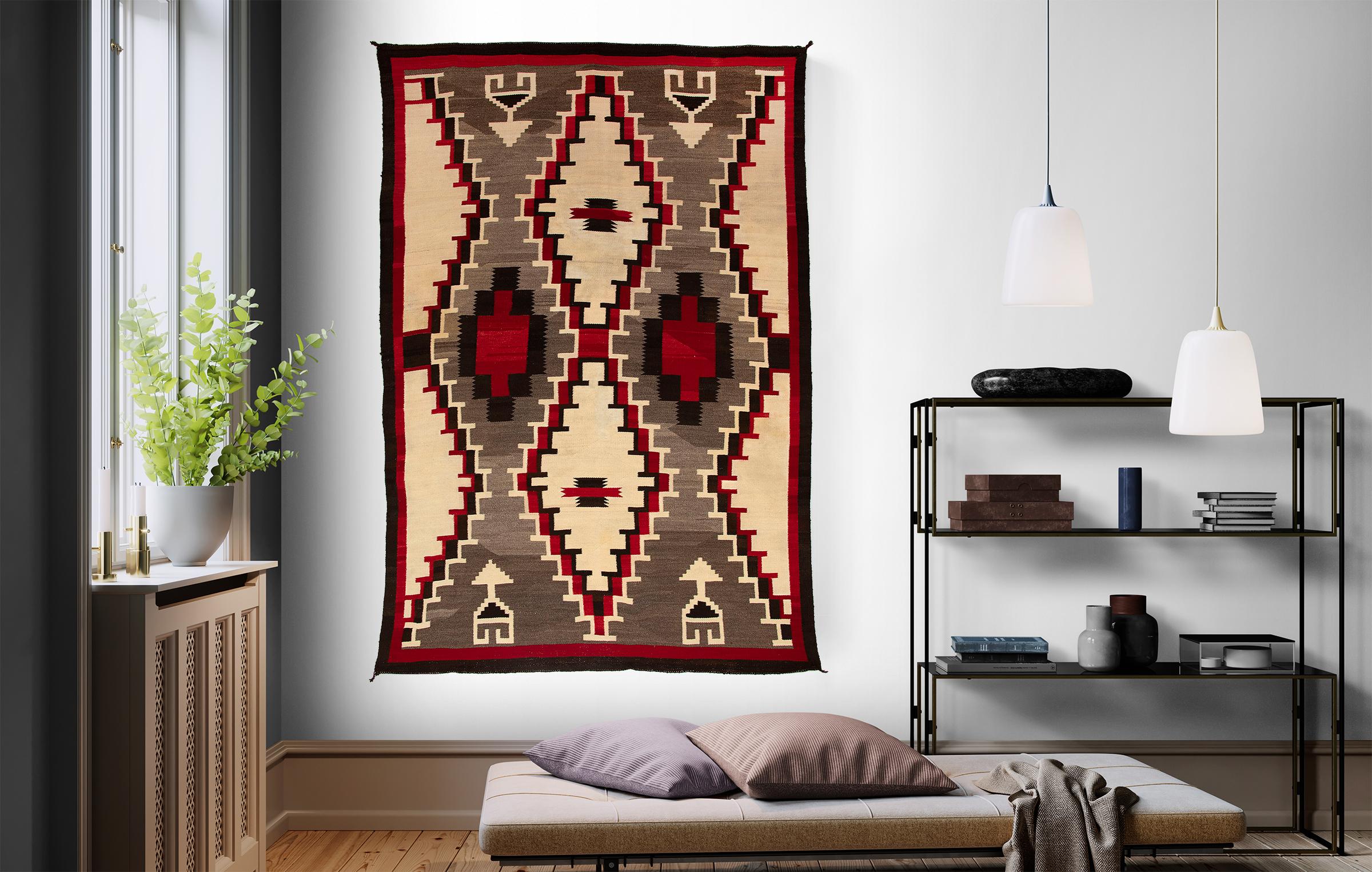 Vintage Navajo Area Rug, Hubbell Trading Post, Ganado design with hourglass, arrow and diamond elements. Woven of native hand-spun wool in natural fleece colors of brown/black, ivory (white), gray/brown with aniline dyed red.  The Hubbell Trading