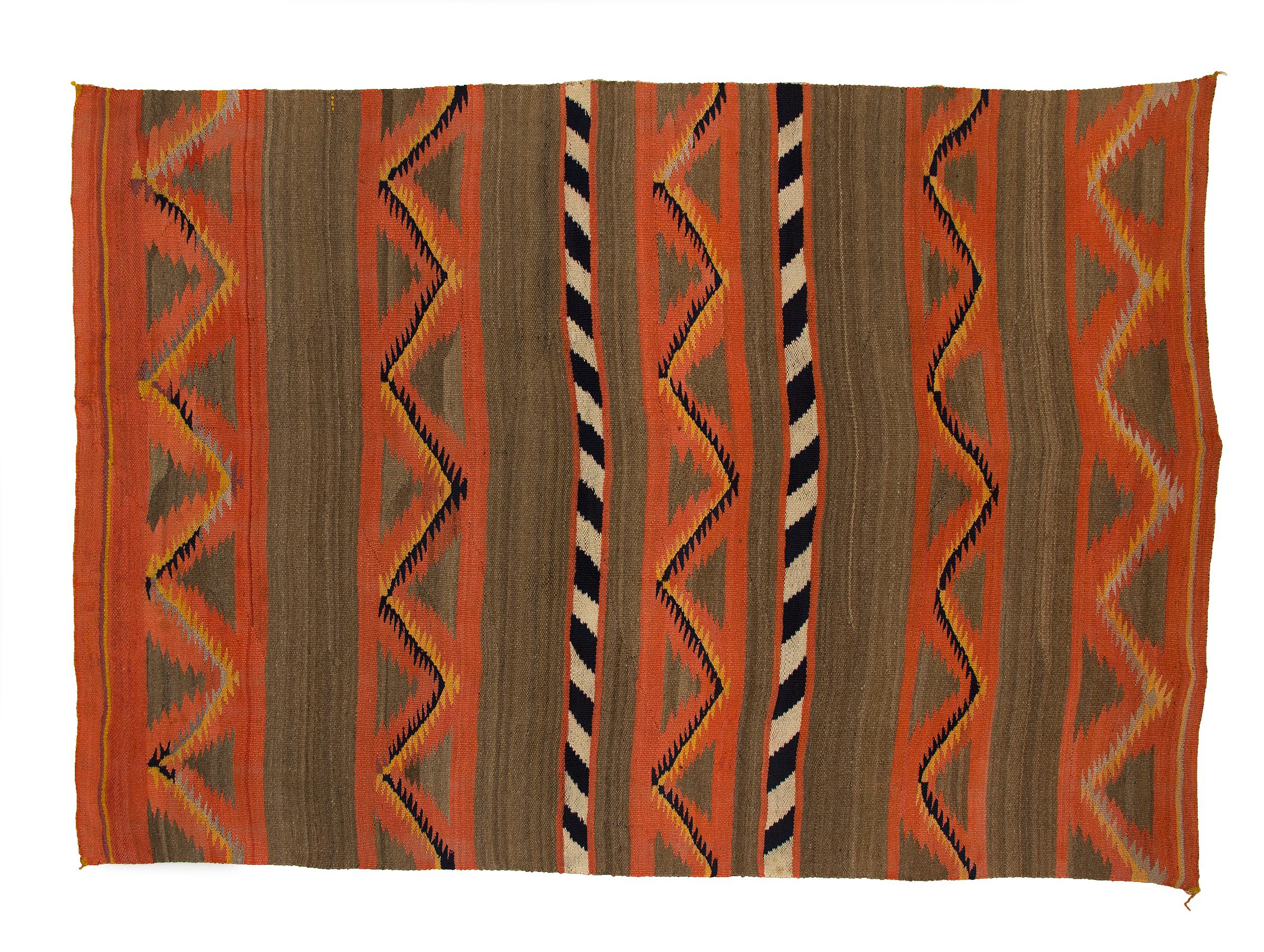 Antique 19th century (circa 1880-1900) Navajo Blanket, woven in a sarape format with a banded design in native handspun wool with natural fleece colors of gray/brown, ivory and black with aniline dyed red/orange and yellow. 
This textile is best