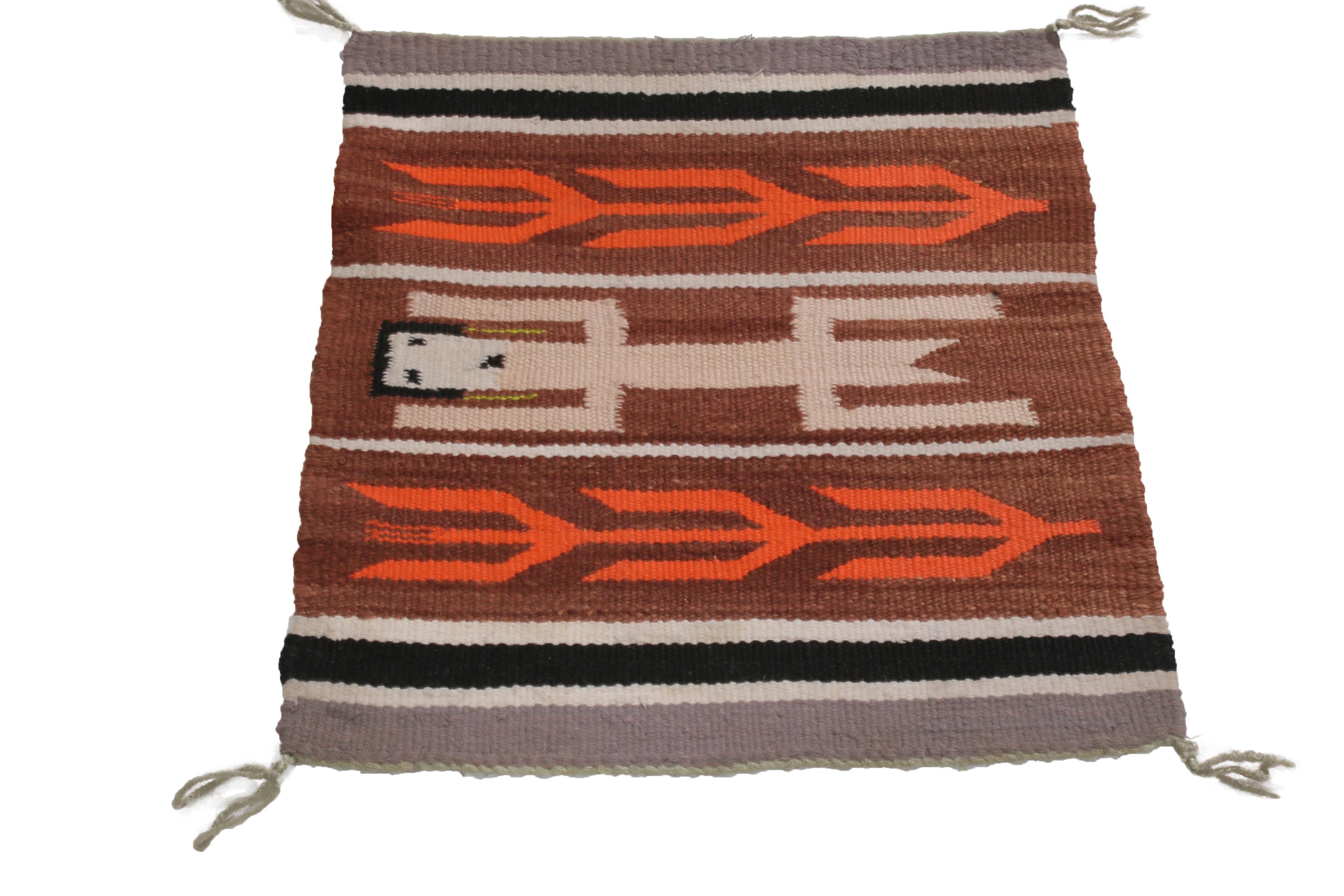 Hand knotted in quality wool from the United States in 1950, this vintage rug employs a marriage of both forgiving and engaging tribal colorways with symbols believed to hail from the Native American Navajo tribe. As one of the largest native tribes