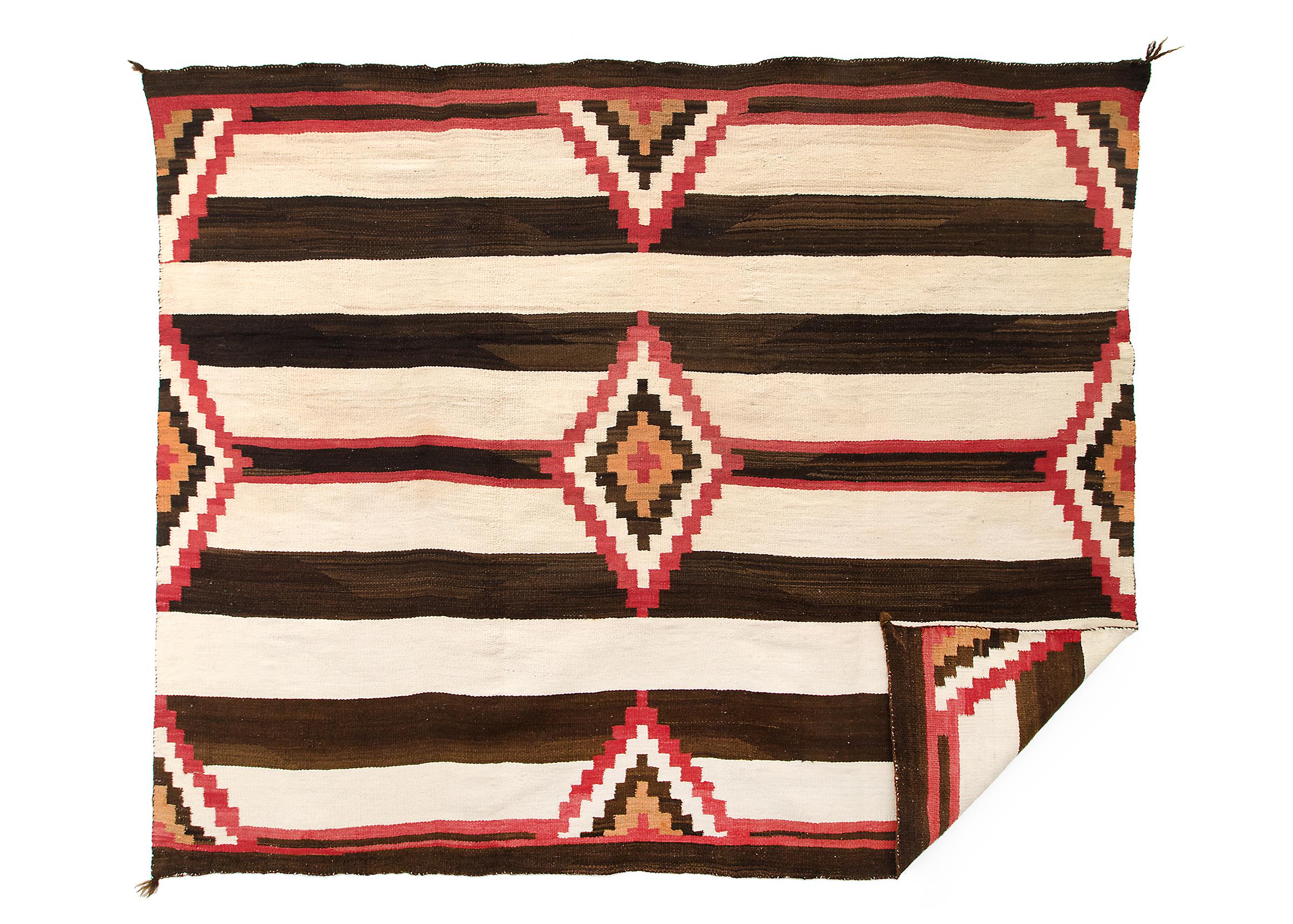 Authentic Third Phase Navajo Chiefs wearing blanket with a nine point diamond pattern against a Classic banded ground dating to the late 19th or early 20th century. Handwoven of native hand spun wool with natural fleece in ivory and brown-black with