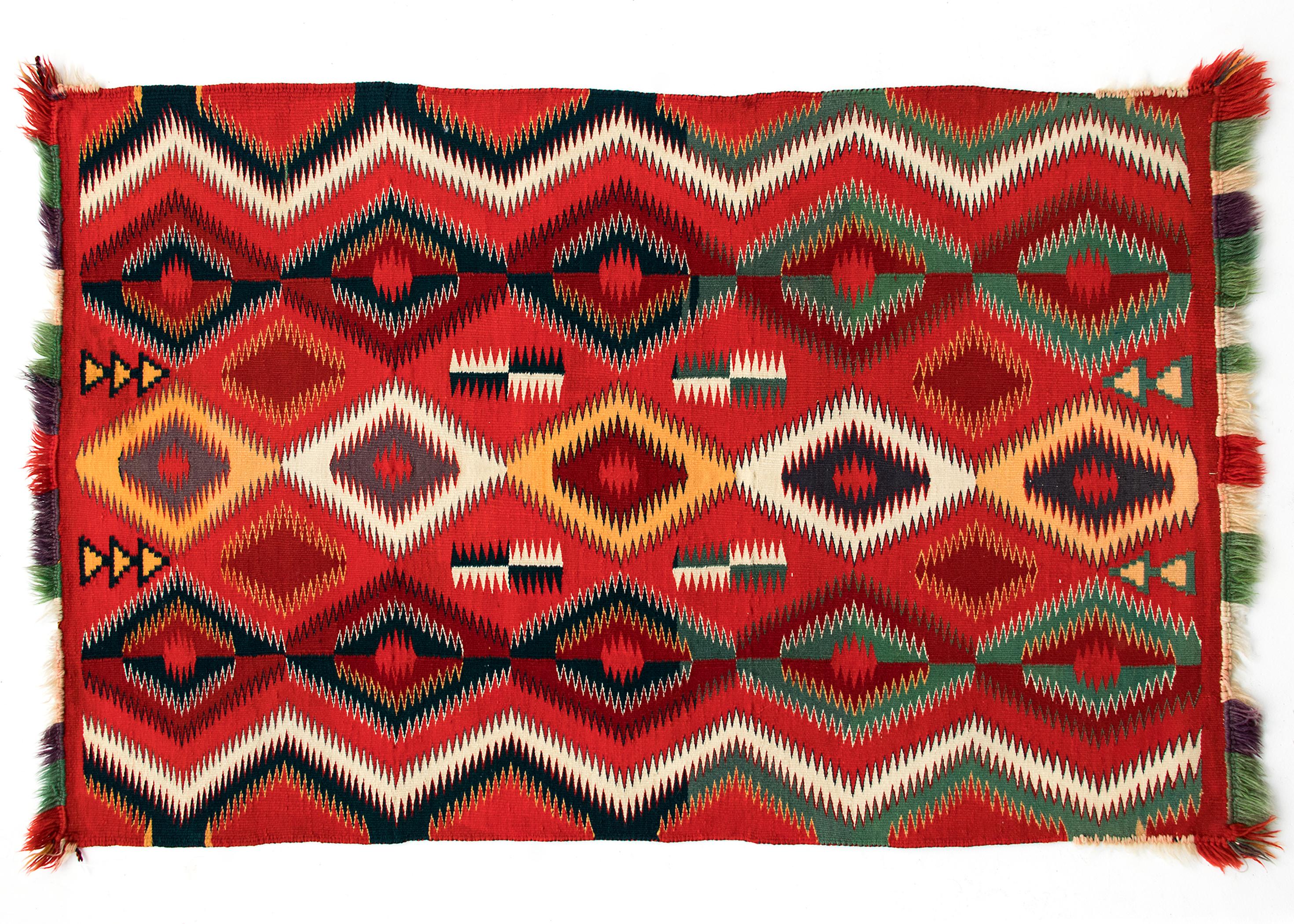 Antique Navajo Blanket woven circa 1890 of Germantown yarns (commercial yarns originating from mills in the area of Germantown, Pennsylvania that became popular in Navajo textiles of the late 19th century) with columns of stacked serrated diamonds