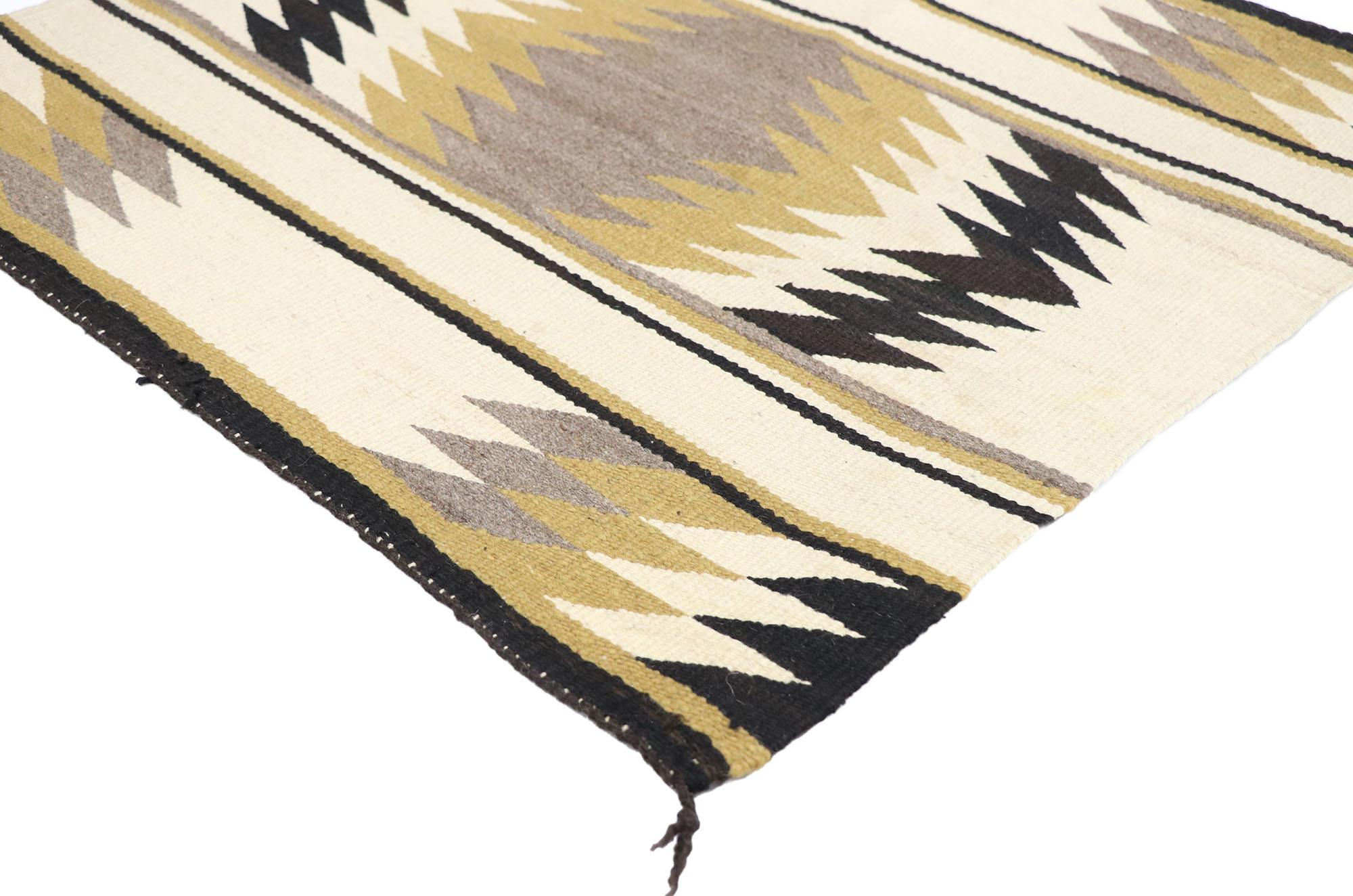 77872, vintage Navajo Kilim rug with Two Grey Hills style9. With its bold expressive design, incredible detail and texture, this hand-woven wool vintage Navajo Kilim rug is a captivating vision of woven beauty highlighting Native American style with