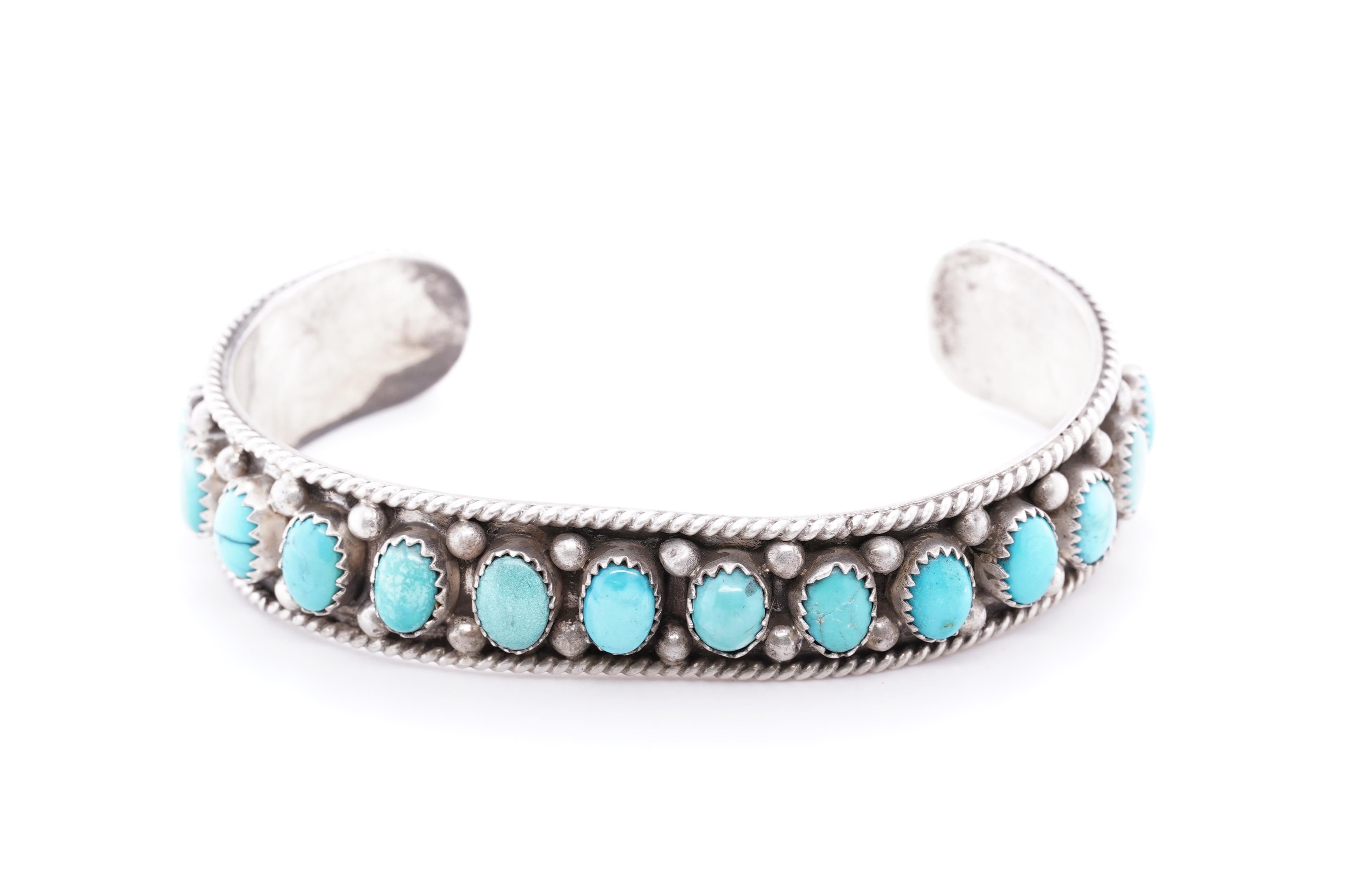 Vintage, Heirloom, Navajo Kingman turquoise bracelet with 15 oval, bezel-set turquoise stones. Silver round beads in-between and the frame is surrounded by a twisted rope border. Turquoise is stunning lighter blue color of excellent quality. No