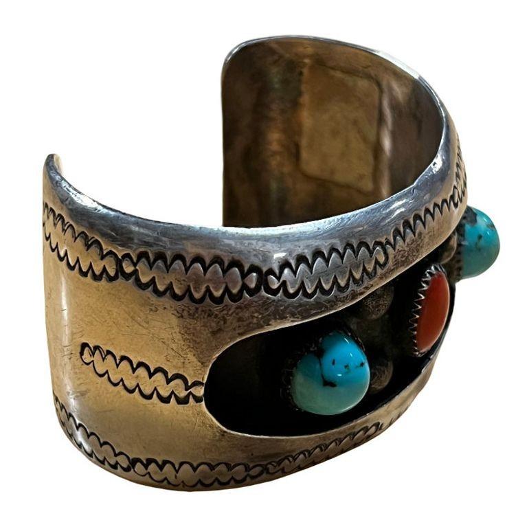 1970 South West Navajo silversmith cuff bracelet, a classic combination of heavy silver and American turquoise and coral stone by jeweler Kathleen Yazzie. The cuff is filled with a magnificent collection of Kingman Turquoise and coral stones with