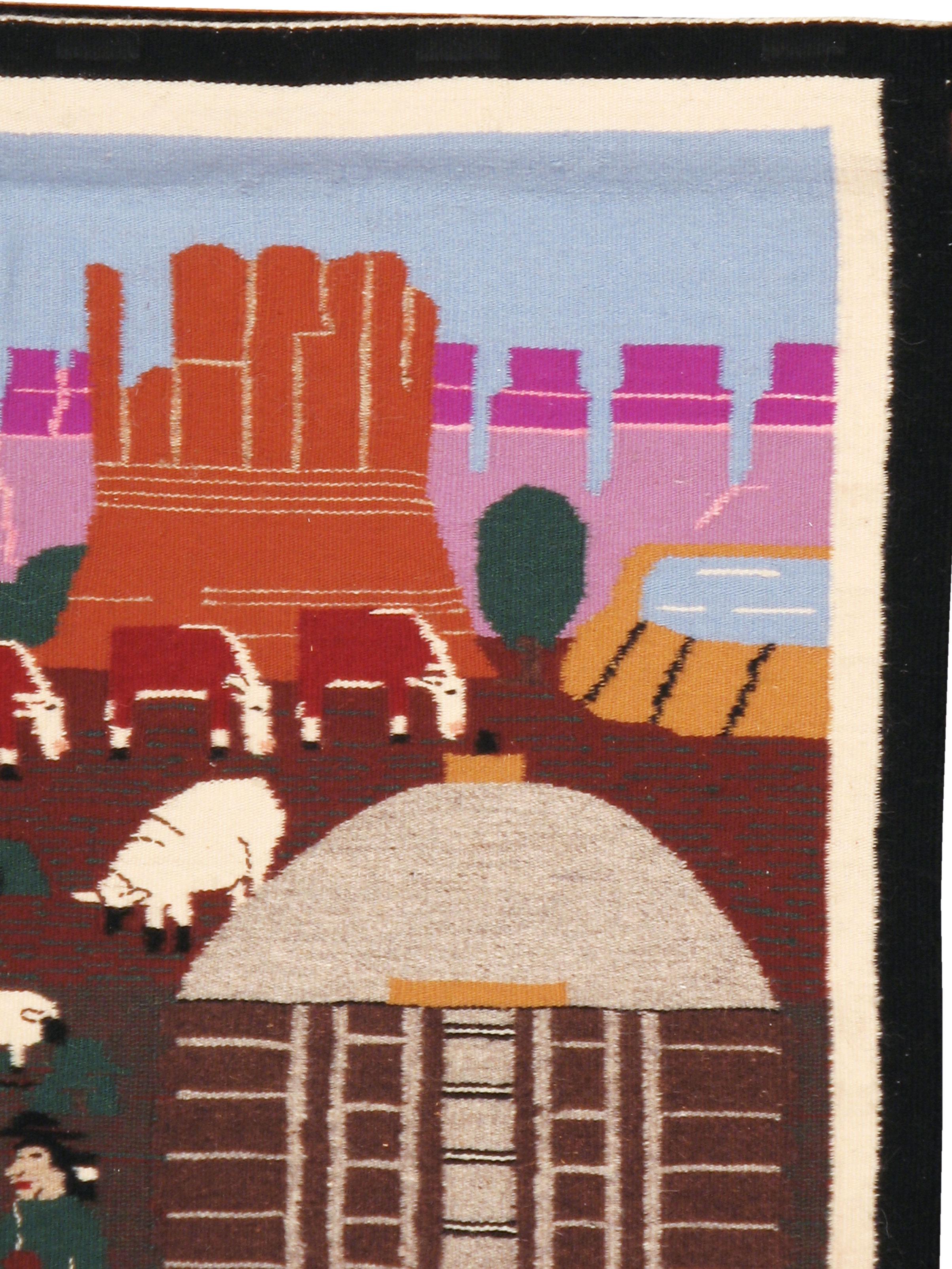 A vintage Pictorial rug handmade by the indigenous Navajo people of North America. Buttes and mesas tower in the background while a partly completed Navajo rug appears on a vertical loom along with its weaver, while other Navajo people, sheep, and