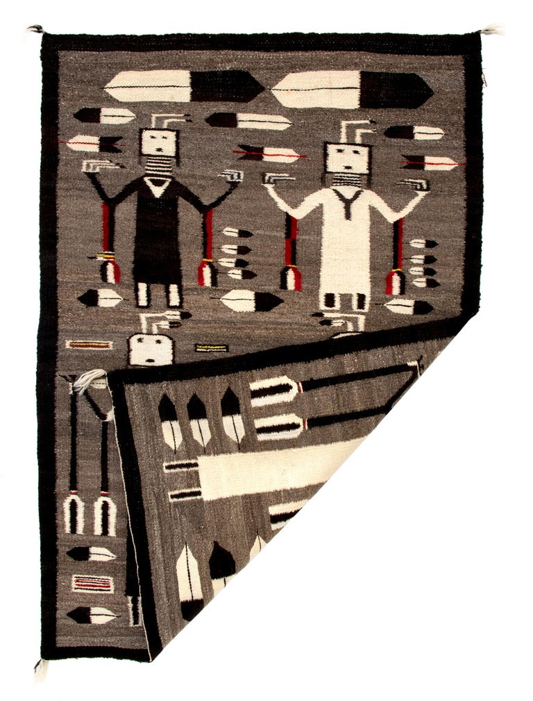 Vintage 1930s Navajo Pictorial weaving with Yei figures and feathers, woven of native hand spun wool in natural fleece colors of white, brown black and gray brown aniline dyed red, orange and yellow. The Yeibichai ceremony, also known as the Night