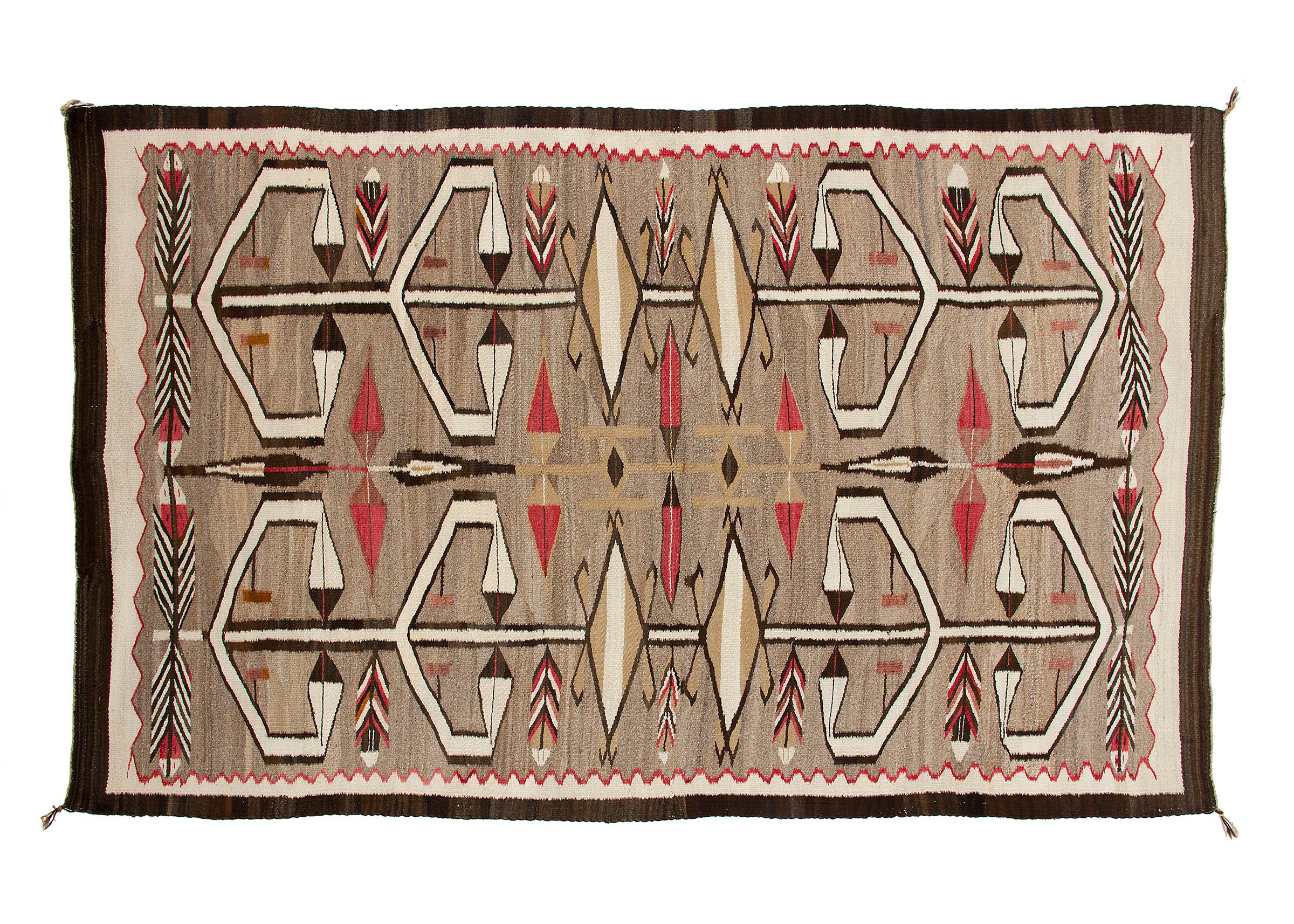 Navajo rug vintage circa 1930s from the Crystal Trading Post (J.B. Moore) at Crystal, New Mexico. Pictorial elements include feathers and arrows. Woven of native hand-spun wool in natural fleece colors of brown, gray, ivory/white, camel, brown/black