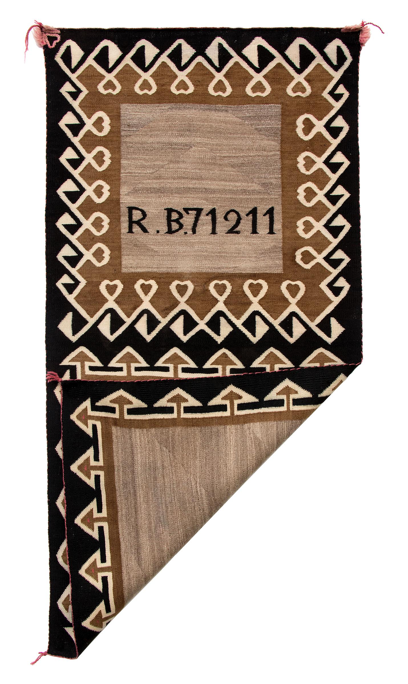 Navajo Double Saddle Blanket, circa 1900. R.B. 71211 woven on front top half. Weaving measures 47 x 23 ¼ inches.