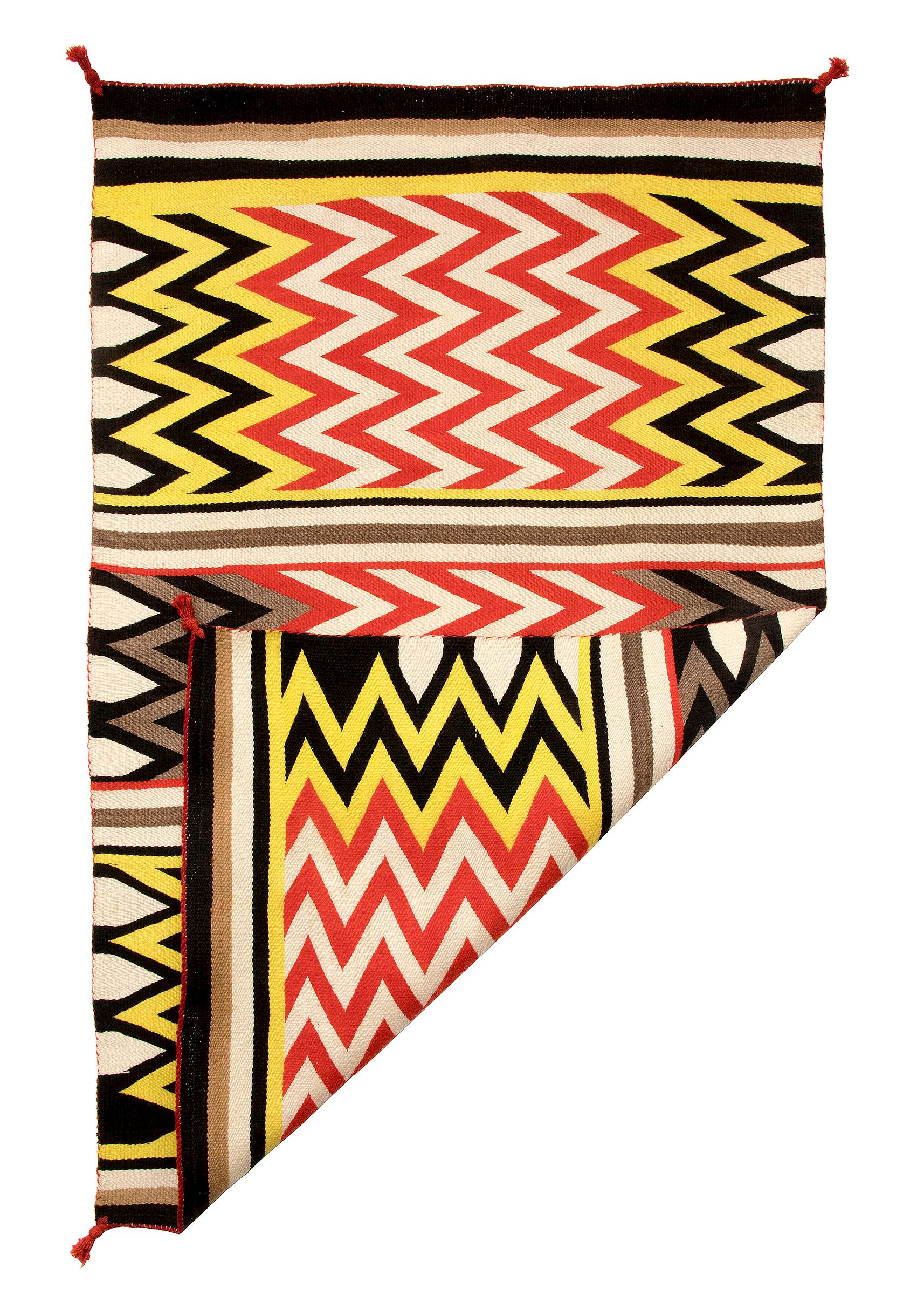 Vintage Navajo rug with a lightning pattern of zig-zag stripes. Southwestern weaving with a bold abstract pattern, woven of native hand-spun wool in natural fleece colors of white/ivory, brown and black with aniline dyed red and yellow. Dimensions