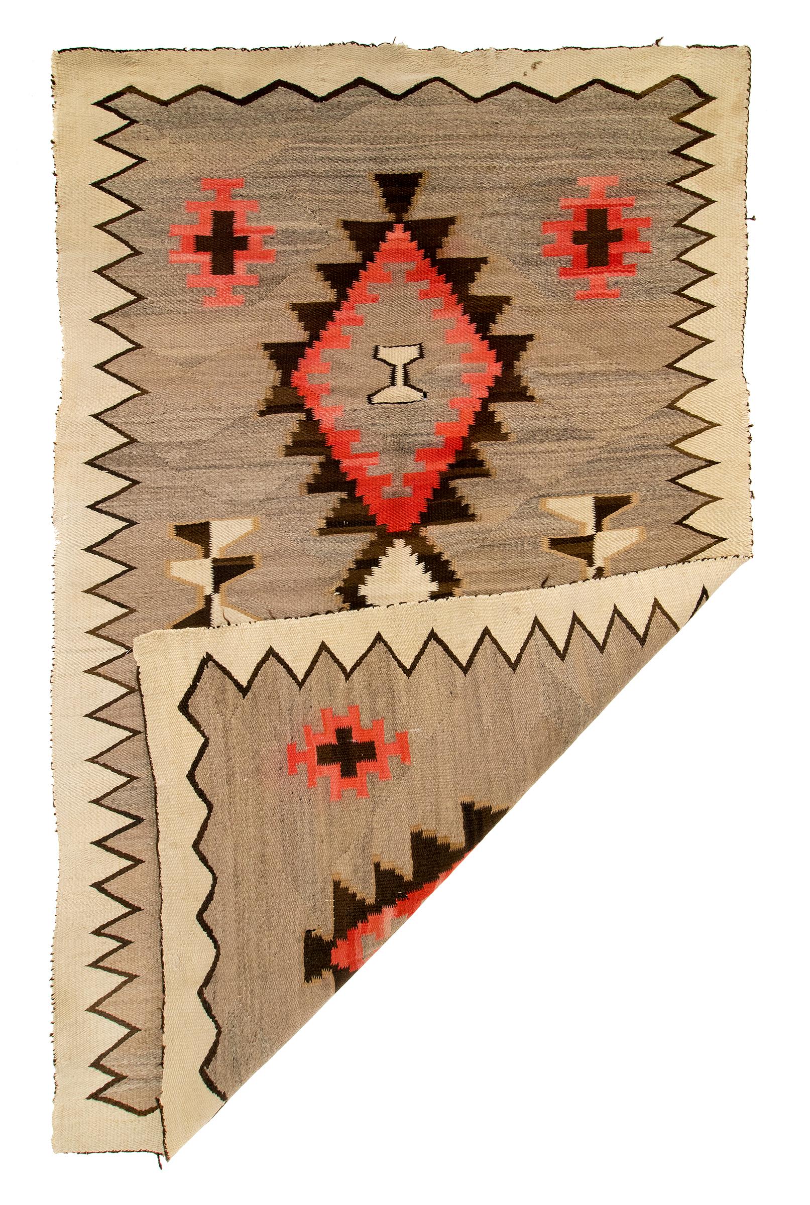 Vintage Navajo rug, Pan-Reservation, Klagetoh style, Trading Post area rug circa 1940s - 1950s. Hand woven of native hand spun wool in natural fleece colors of gray, ivory and brown with aniline dyed red. Design elements include crosses, diamonds,