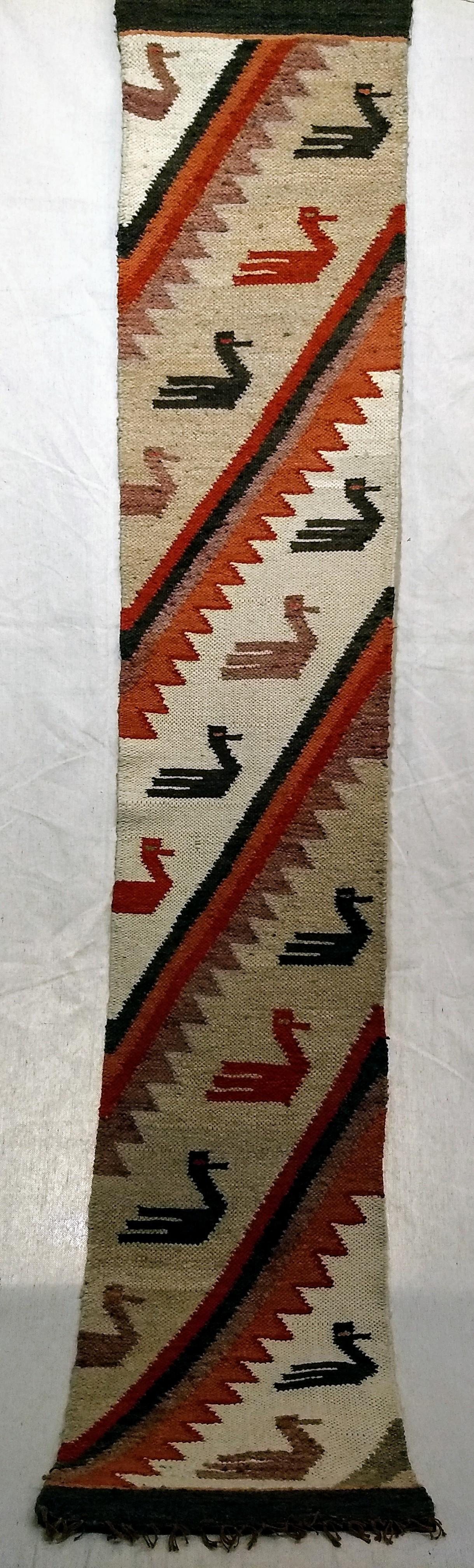 Vintage Native American Navajo Rug Depicting a Column of Birds for Wall Art a Table Runner.  The beautiful Navajo rug from the Southwest Area of America has a very unique design of birds woven into a stripes pattern. The Navajo rug has been adapted