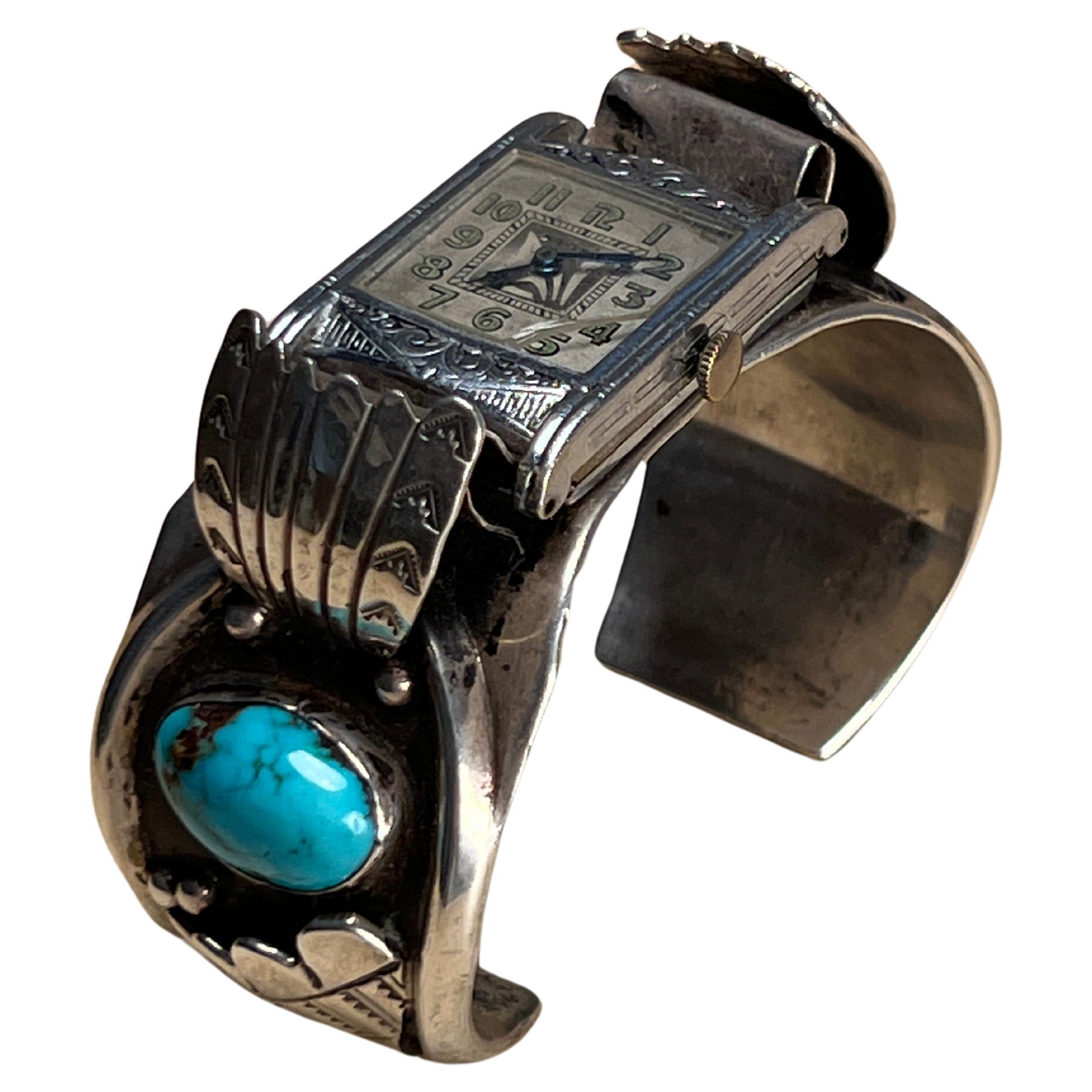 This listing features a substantial vintage Navajo sterling silver watch bracelet, expertly crafted with intricate details. The bracelet showcases a traditional Navajo design with detailed engraving and two striking turquoise stones set on either