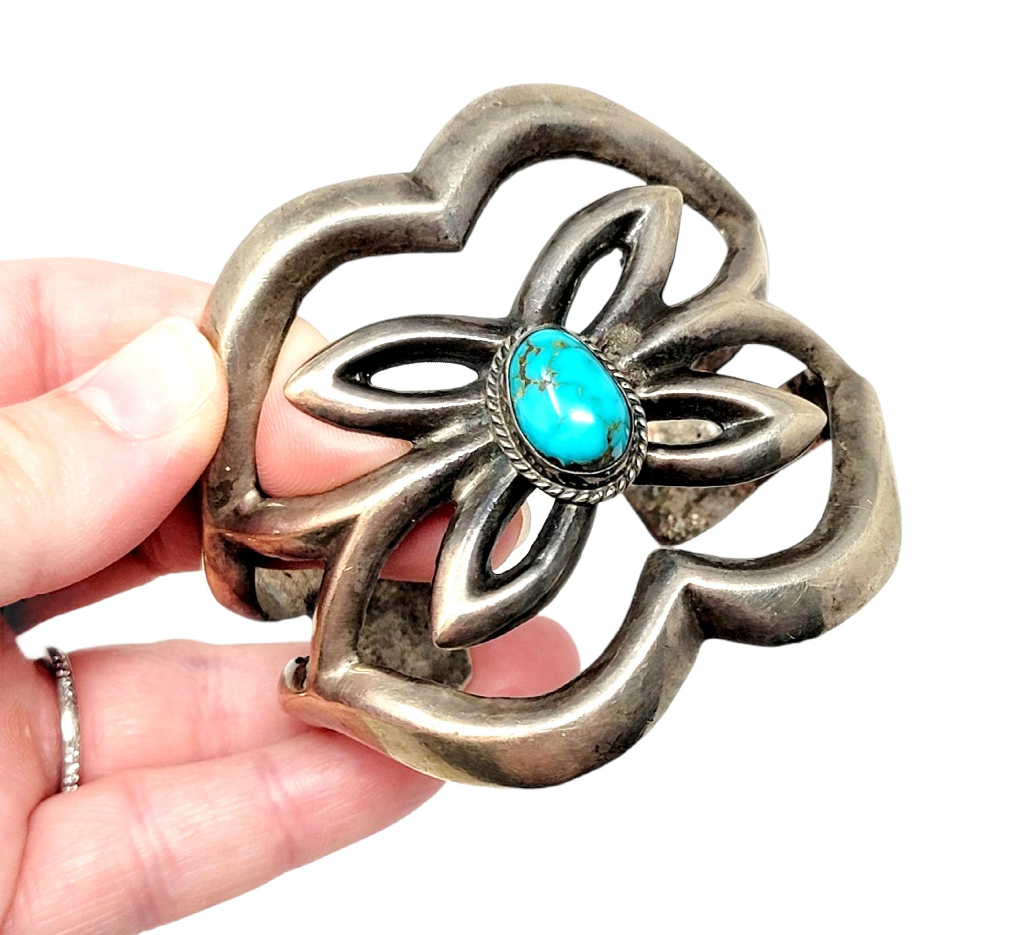 Stunning bold sterling silver and natural turquoise cuff bracelet. This wide, artfully constructed piece features a chunky, wide Navajo design accented by a single bezel set cabochon turquoise stone. This incredible bracelet fills the whole wrist