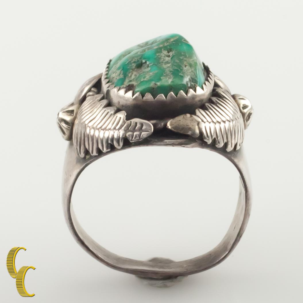Native American sterling silver ring with tumbled turquoise in a bezel setting.
The turquoise has a nice greenish emerald hue.
Size: 10.75.
Length of Setting: 27 mm.
Metal: 0.925 sterling silver.
Weight: 18 grams.