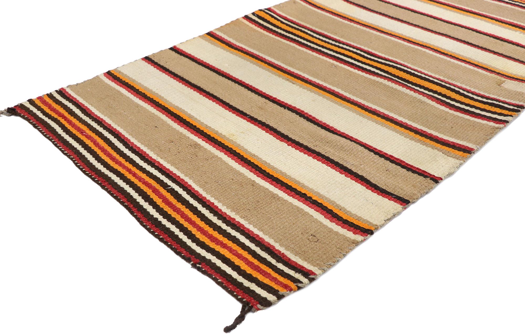 77846 Vintage Navajo stripe blanket Kilim rug, 02'07 x 04'11. With its warm hues and rugged beauty, this handwoven wool vintage Navajo stripe blanket kilim rug manages to meld contemporary, modern, and traditional design elements. The flatweave