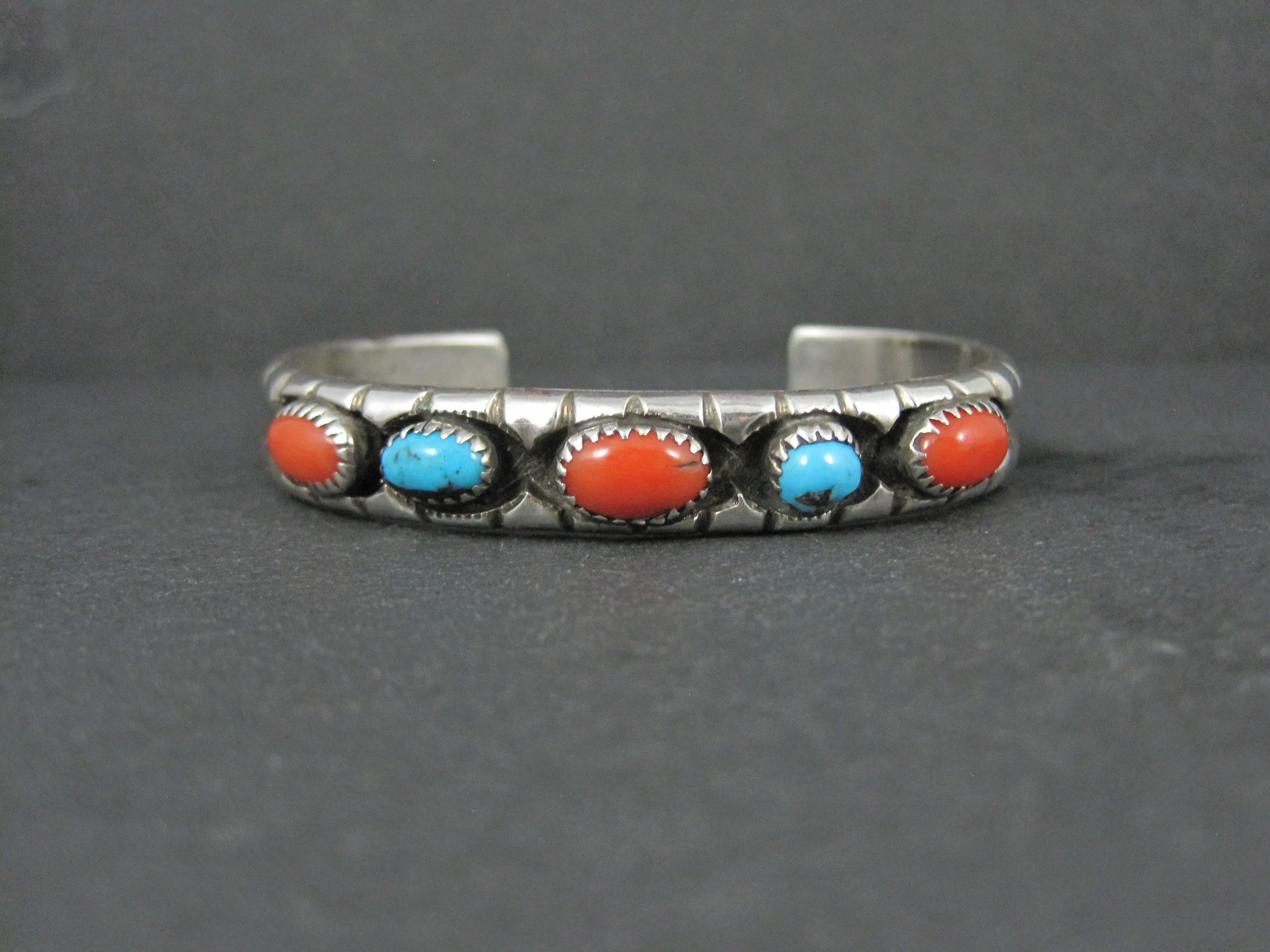 This gorgeous vintage cuff bracelet is sterling silver with 2 turquoise and 3 coral gemstones.
It is a product from famed Navajo Silversmith Eunice Claw.
This bracelet measures 3/8 (10mm) of an inch wide and has an inner circumference of 6 1/4