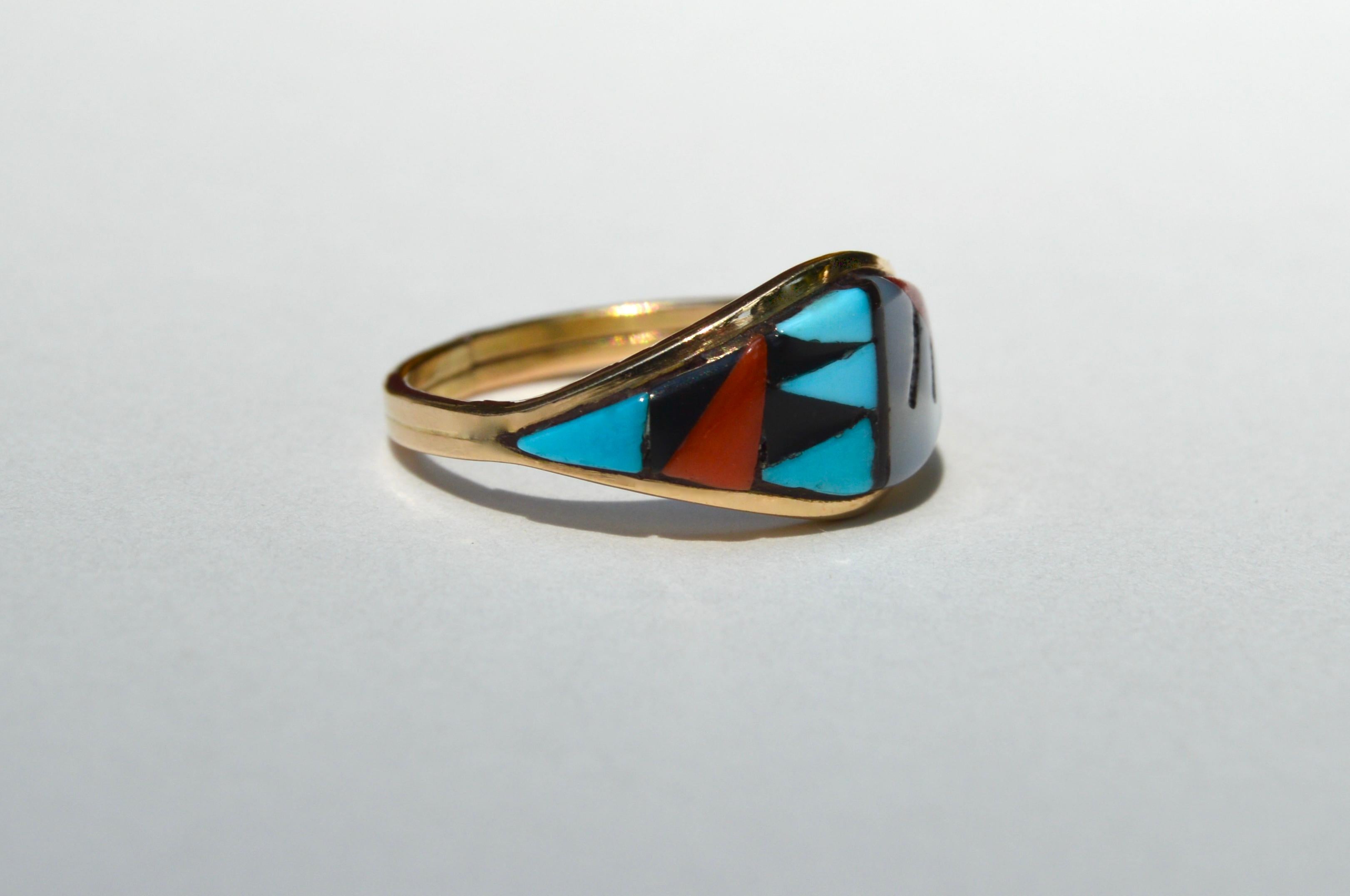 Vintage c1980s 14K yellow gold deadstock Navajo inlay band with onyx, turquoise, red coral and mother of pearl. Size 5.25. In very good condition, has faint resize mark at back of shank. Ring weighs 2.14 grams. Widest point at face measures 10mm.