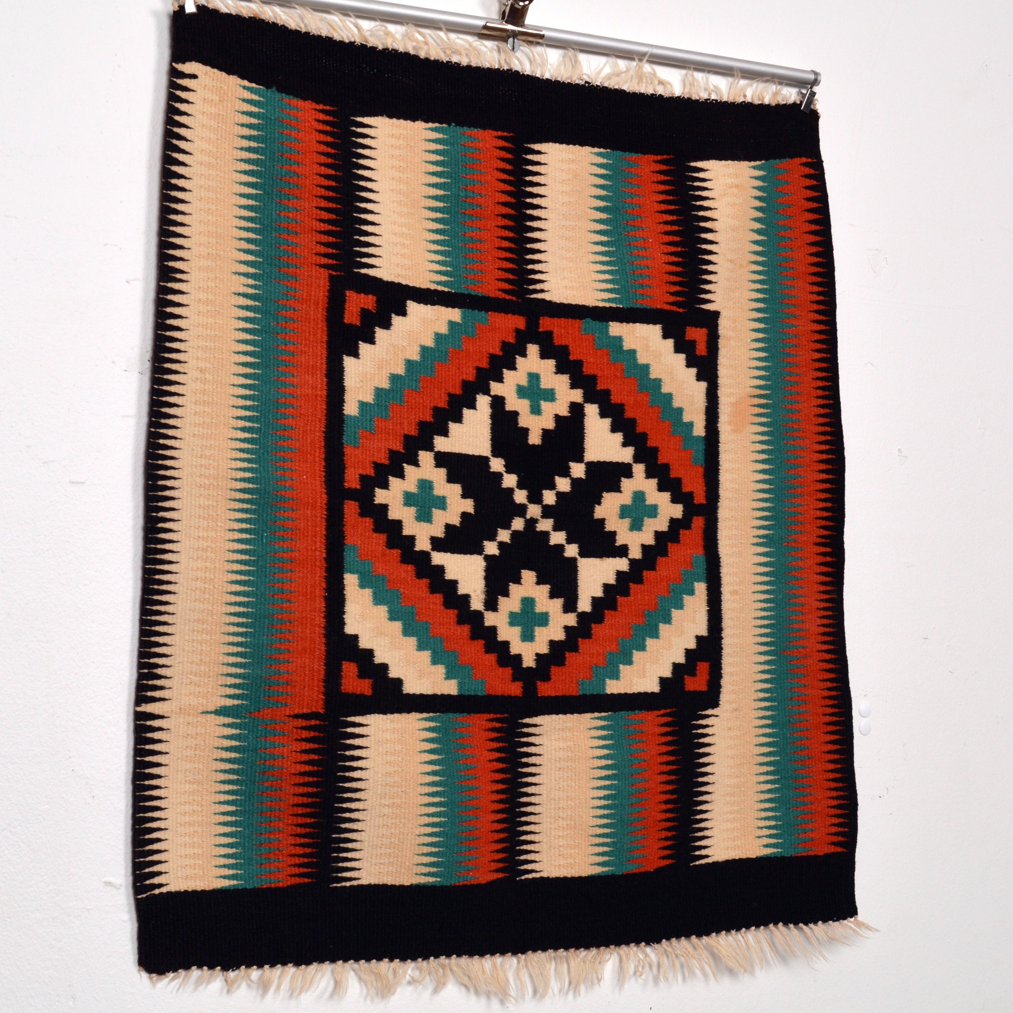 Beautiful little tapestry / wall hanging or table decoration with a geometrical Navajo design pattern. Woven with wool on cotton. Very good vintage condition. Dimensions excludes the fringes.
 