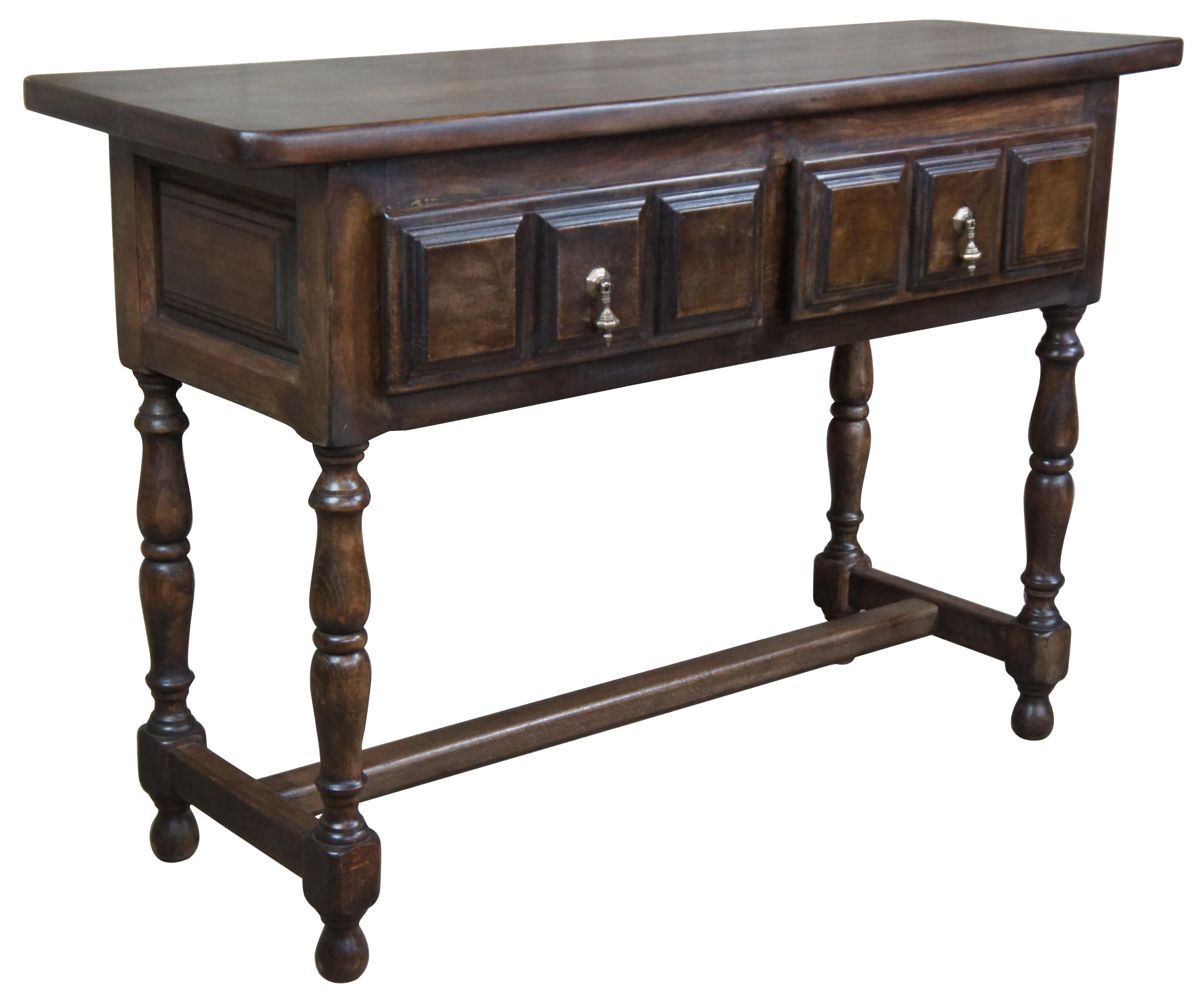 Vintage hall table by Navarro Argudo of Spain. Features Spanish or Jacobean styling with tear drop hardware and paneled front accents. Measures: 33”.