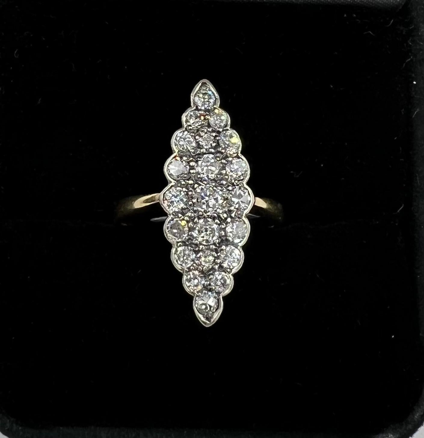 Vintage Navette Diamond Cluster Ring, circa 1930.
 This Vintage Navette Diamond Cluster Ring is a timeless piece of jewelry that exudes elegance and sophistication. With its intricate design and sparkling diamonds, this ring is sure to make a