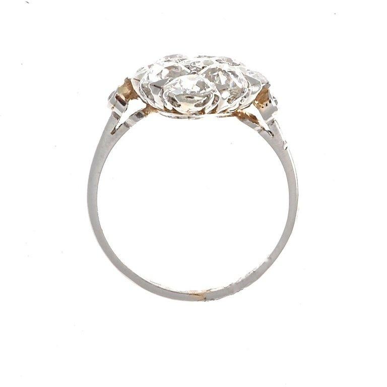 A splash of diamonds dares to catch any passerby's attention. Featuring 9 old cut near colorless diamonds weighing approximately 1.50 carats total. Crafted in platinum. Ring size 4-1/2 and can easily be resized to fit, if needed this would come