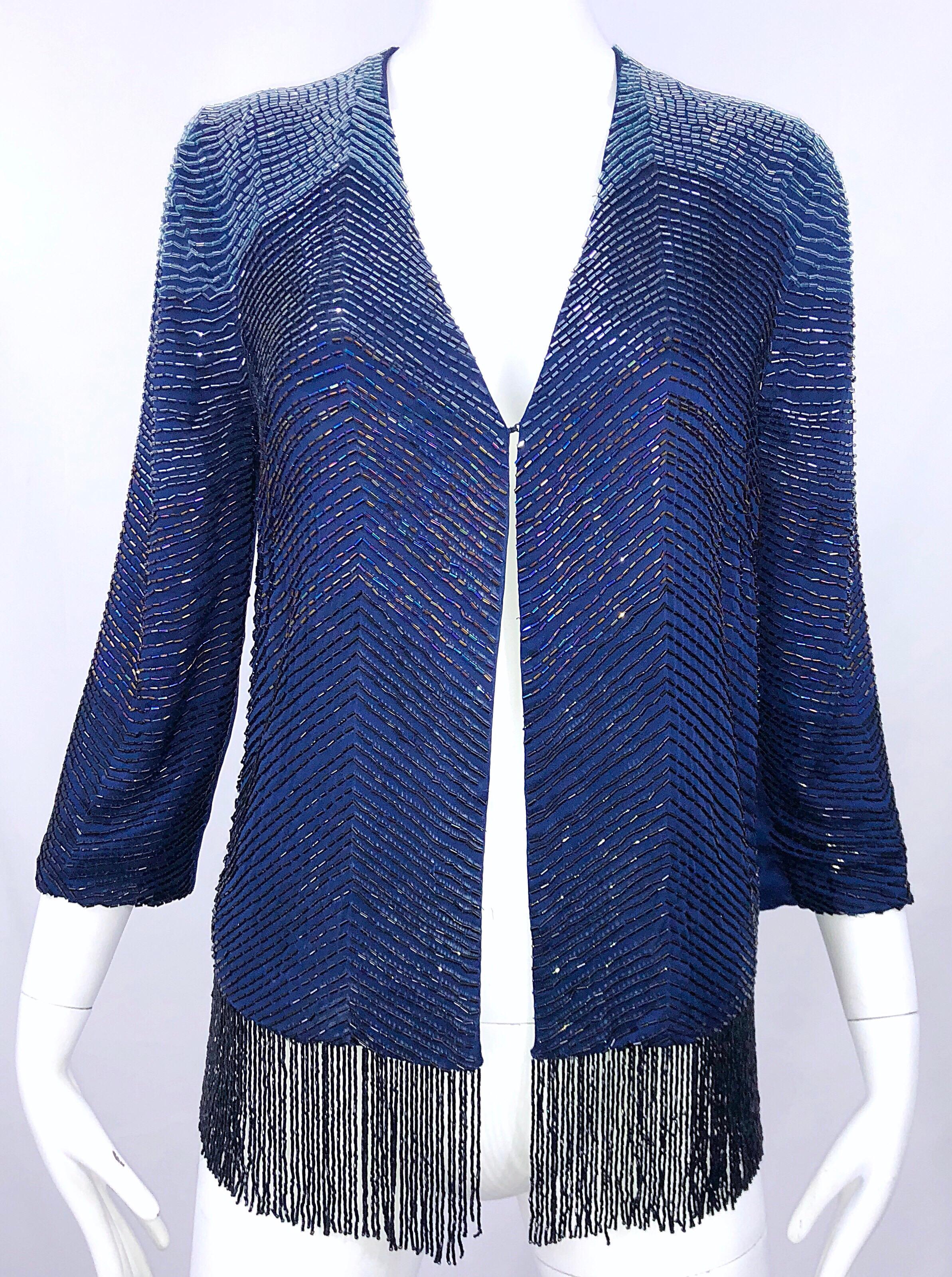 Incredible vintage beaded silk 3/4 sleeve navy blue beaded cardigan! Luxurious navy blue silk with hundreds of hand-sewn beads throughout the front and back. Beaded tassel fringe along the hem. Single hook-and-eye closure. Can easily be dressed up