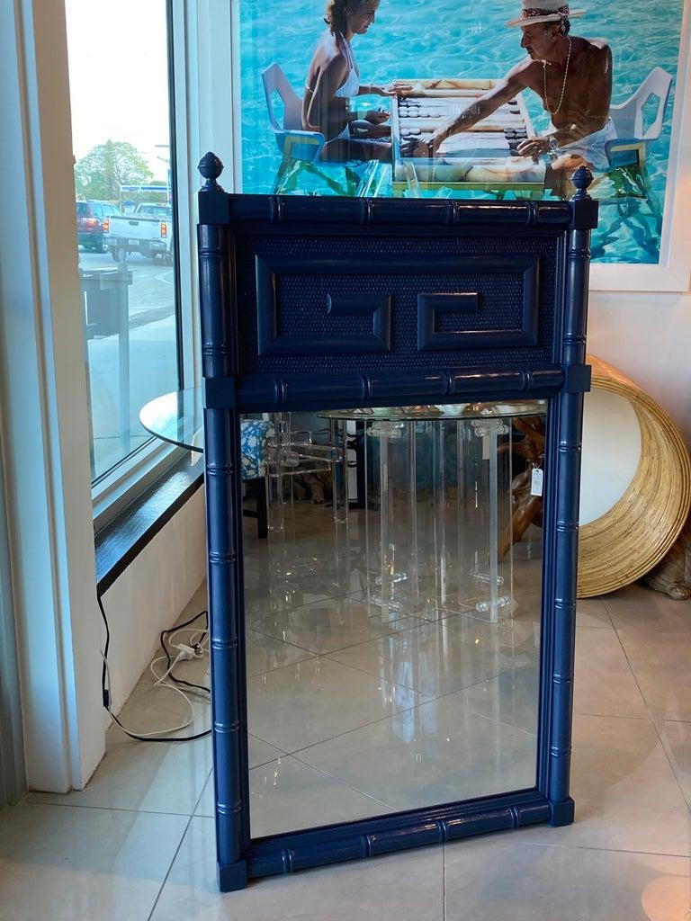 Lovely vintage navy blue lacquered greek key faux bamboo wall mirror. Comes ready to hang. Pair available.
