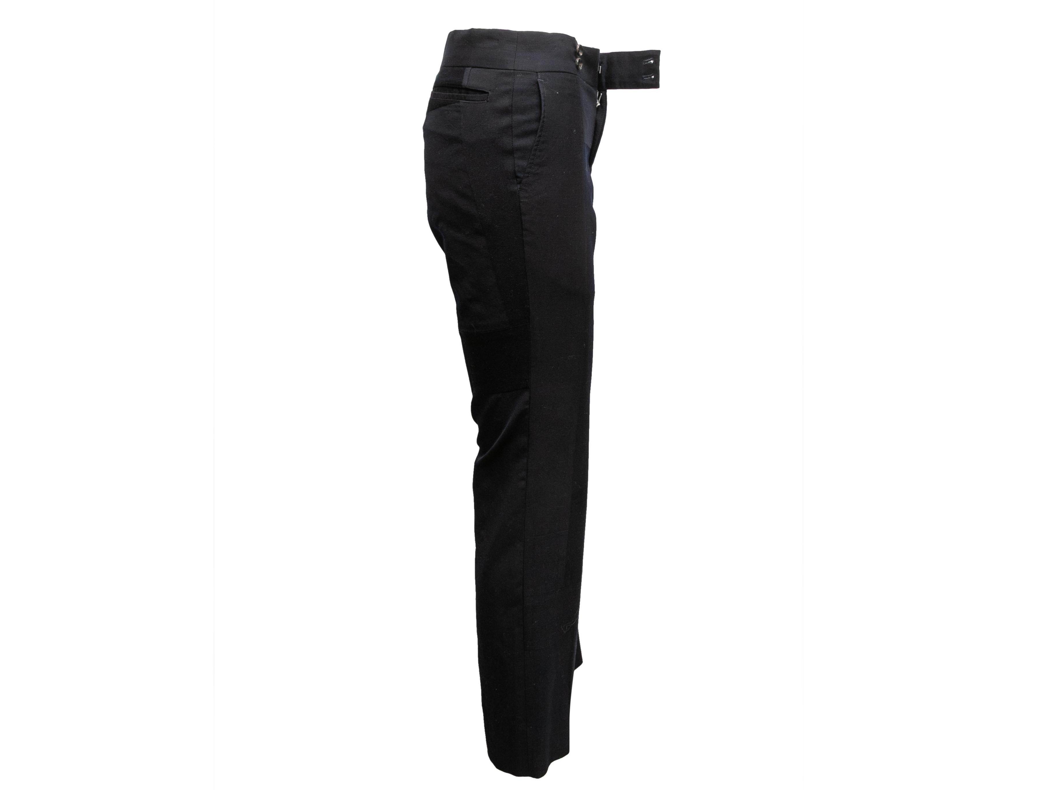 Product Details: Vintage navy wool trousers by Comme des Garcons. From the Fall/Winter 2003 Collection. Four pockets. Front zip and button closures. 30