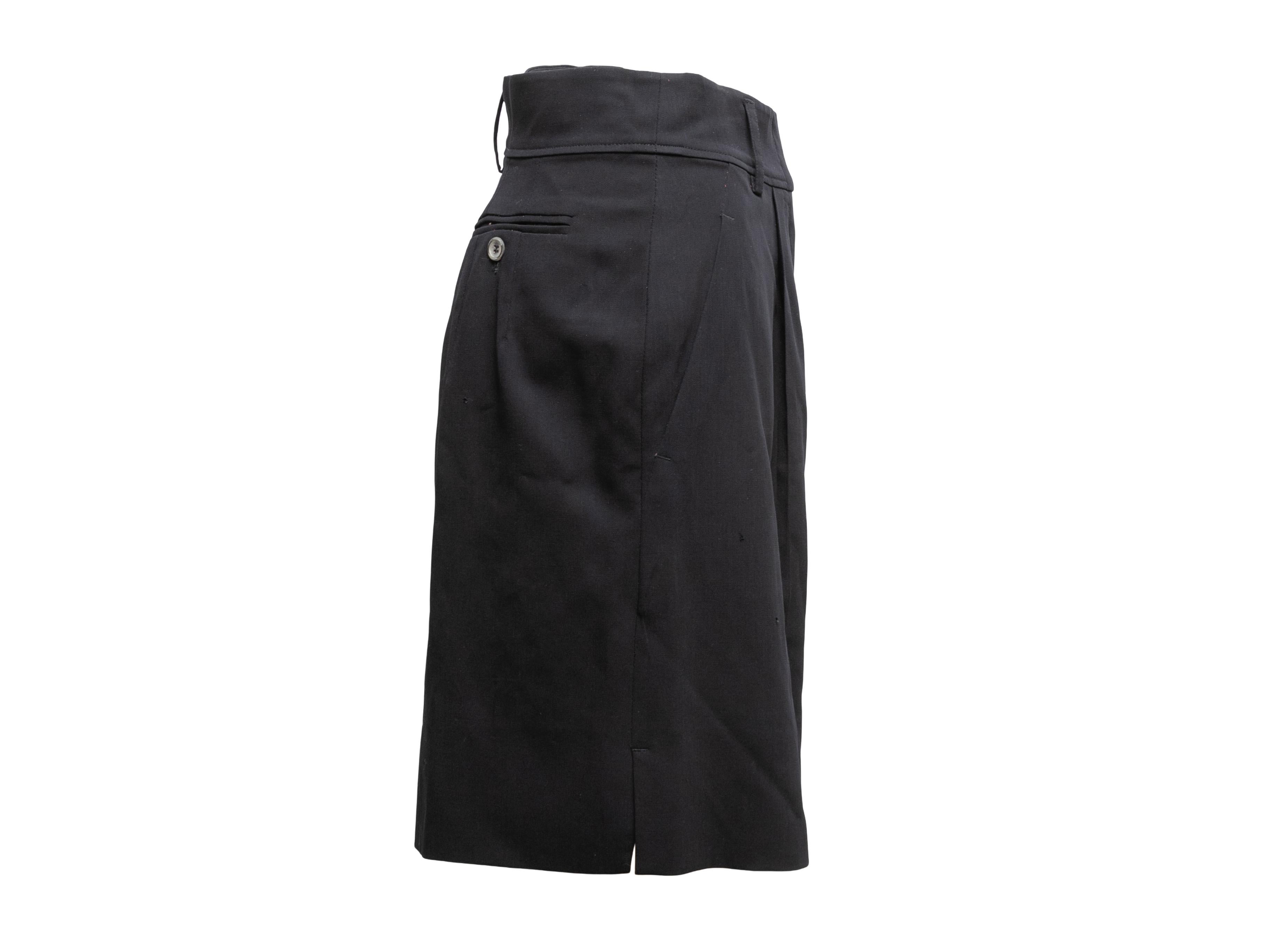 Vintage navy wool mid-length shorts by Jil Sander. Circa 1990s. Three pockets. Zip and hook-and-eye closures at front. 28