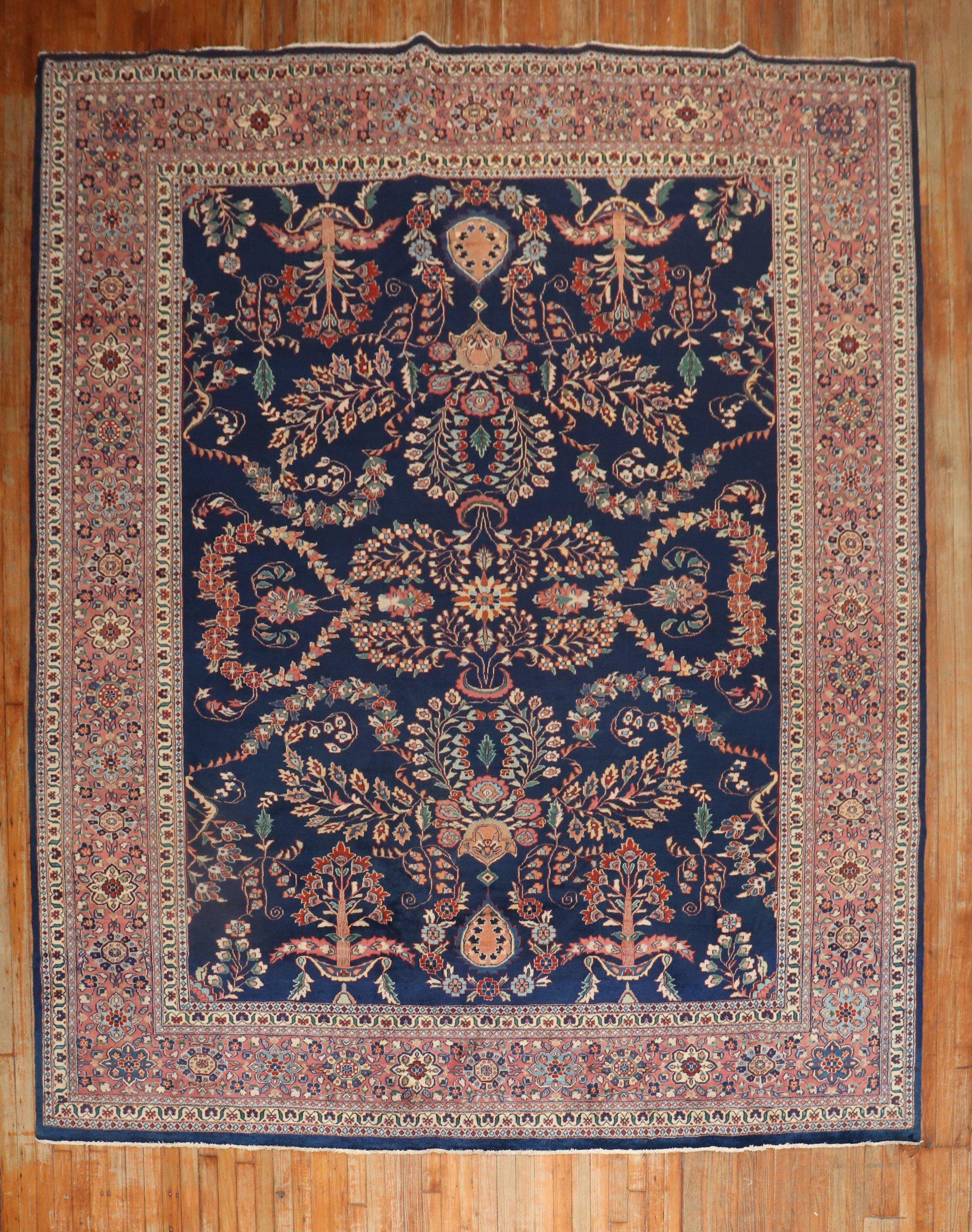 An authentic 3rd quarter of the 20th-century Persian Sarouk rug with a floral design on a navy ground.

Measures: 9'1