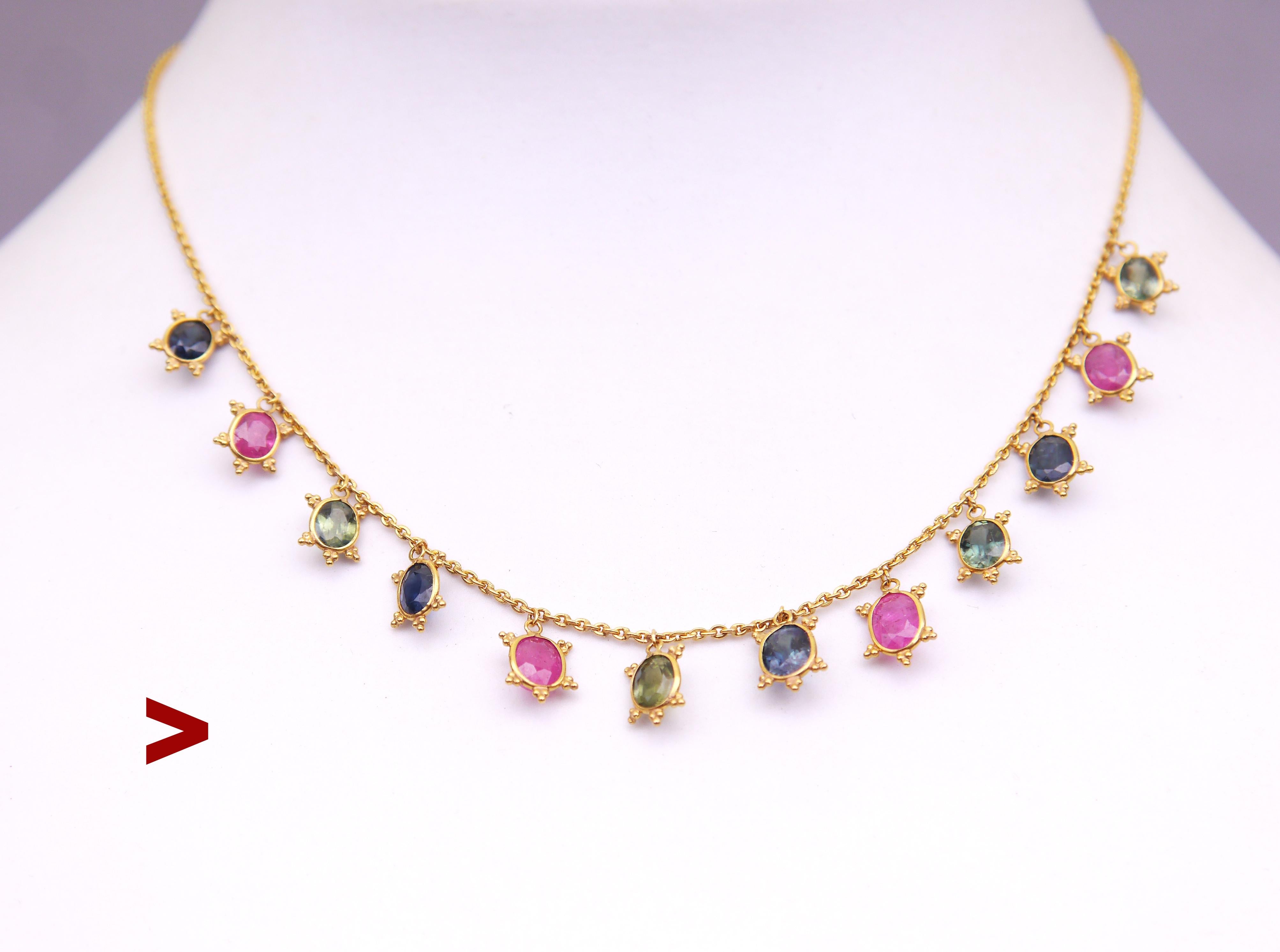 Necklace in solid 21K Gold featuring 12 Green and Blue Sapphires mixed with pinky-red rubies.

All stones are oval-cut untreated naturals with visible flaws and inclusions/.

All stones of slightly different dimensions:

Average measurements 5.75 mm