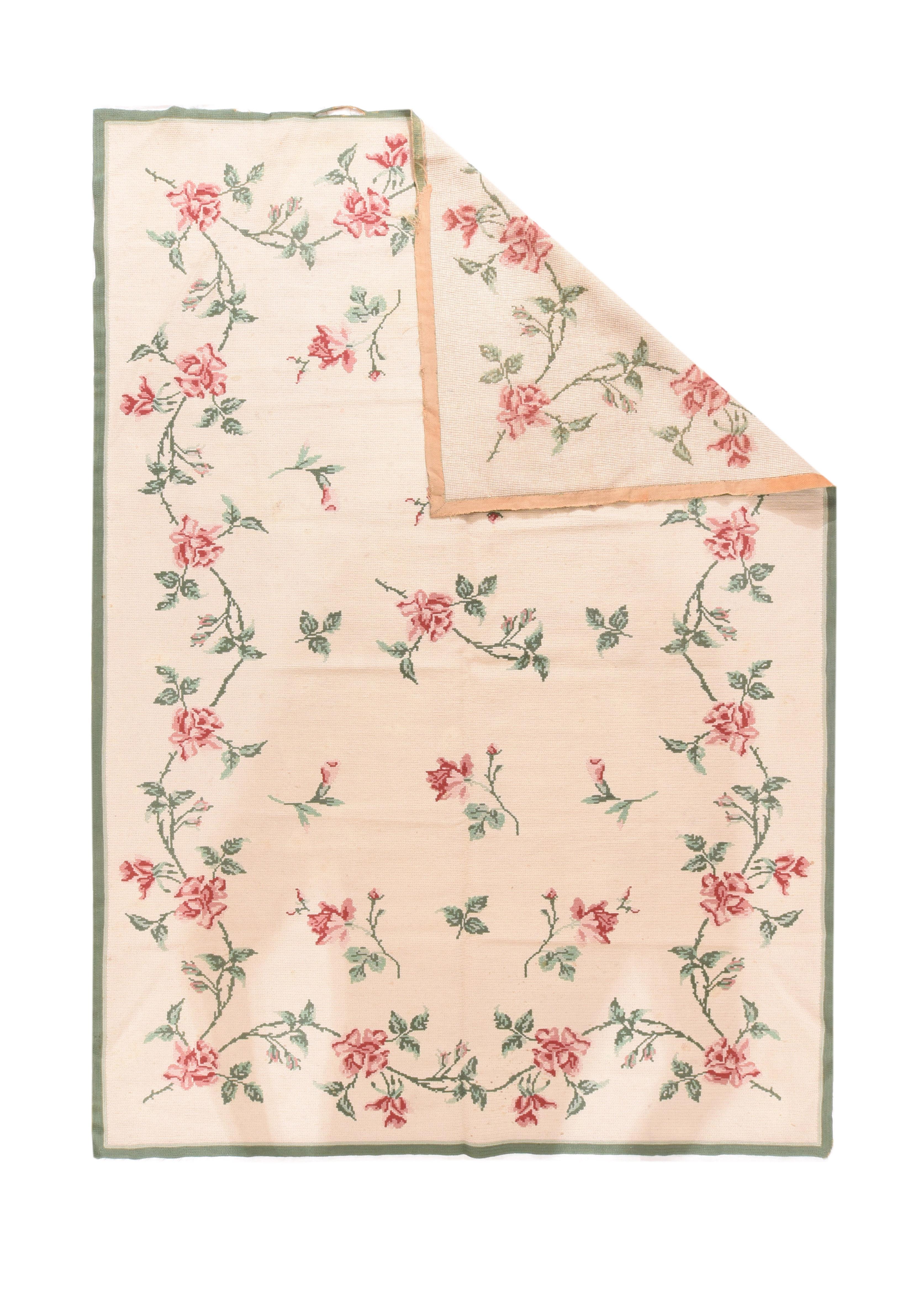 Vintage Needle point rug 8.9'' x 9.10''. The sandy-straw field shows an open pattern of drifting rose stems, within an undulating en suite rose, and leaf thorny meander, all accented in pinks. Narrow plain border. Good condition with ends that need