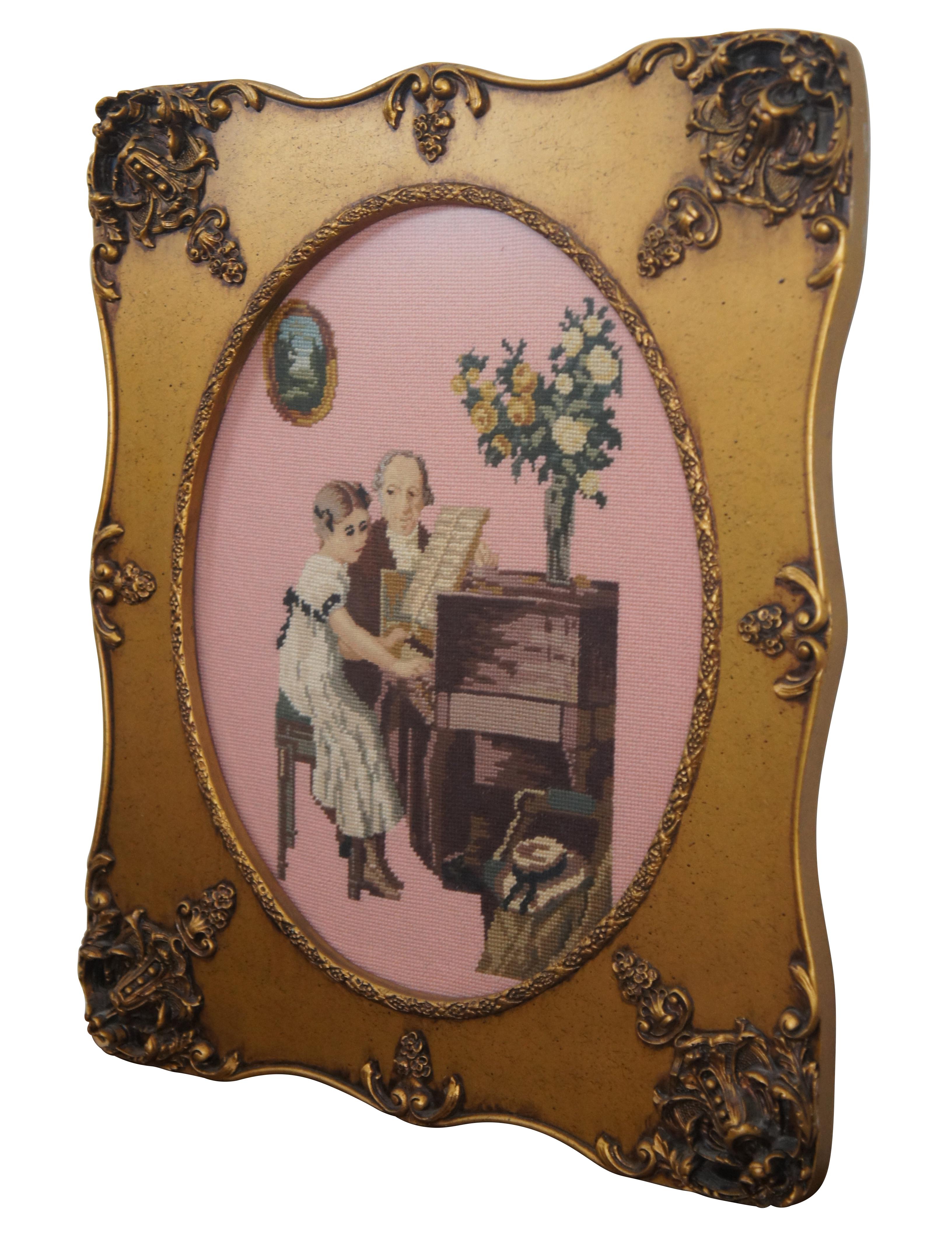 Vintage embroidered scene / tableau showing a young girl and older man in Regency era attire. After work by Jules Alexis Muenier, titled The Piano Lesson. Framed in a scalloped giltwood frame with ornate details.

DIMENSIONS

21.5” x 1” x 25.5”