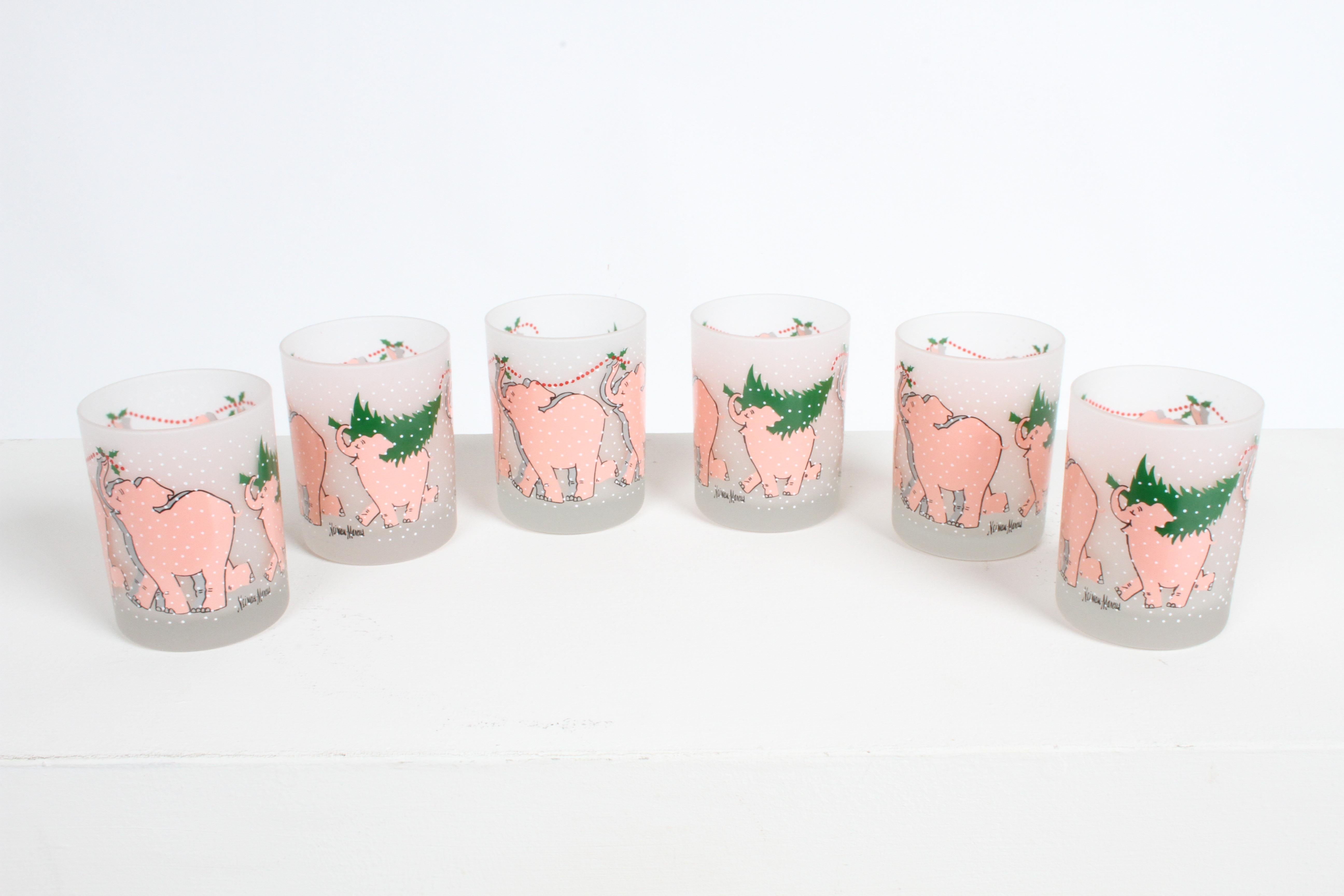 Vintage 1980s barware by Neiman Marcus, this set of six rock glasses with Holiday theme of Christmas Trees, Holly berries and Pink Elephants, printed on frosted glass. They appear to never have been used. No issues.