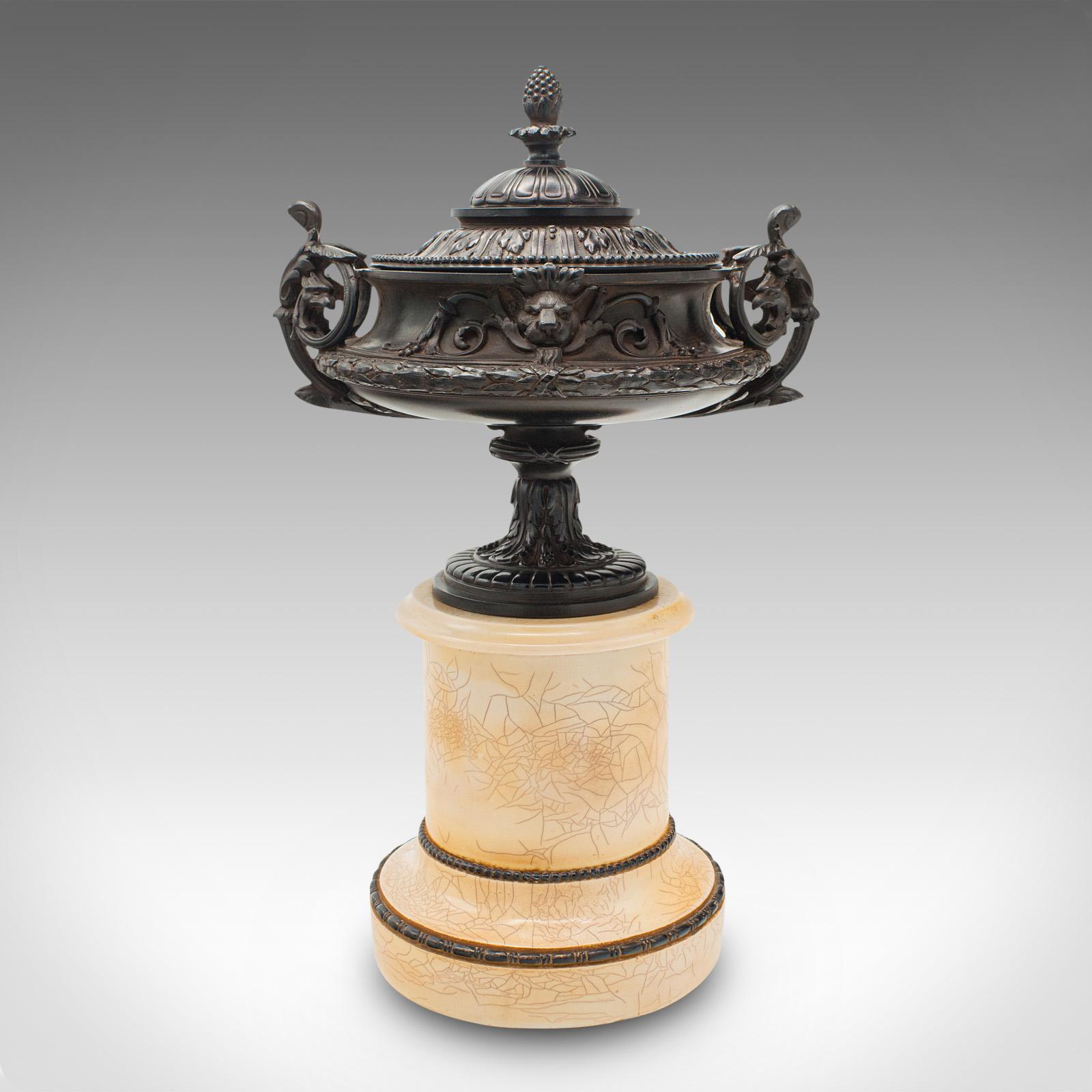 This is a vintage neo-classical urn. A Continental, Bakelite decorative ornament in Grand Tour taste, dating to the early 20th century, circa 1930.

Striking forms, with serpentine flourishes throughout
Displaying. desirable aged patina and in good