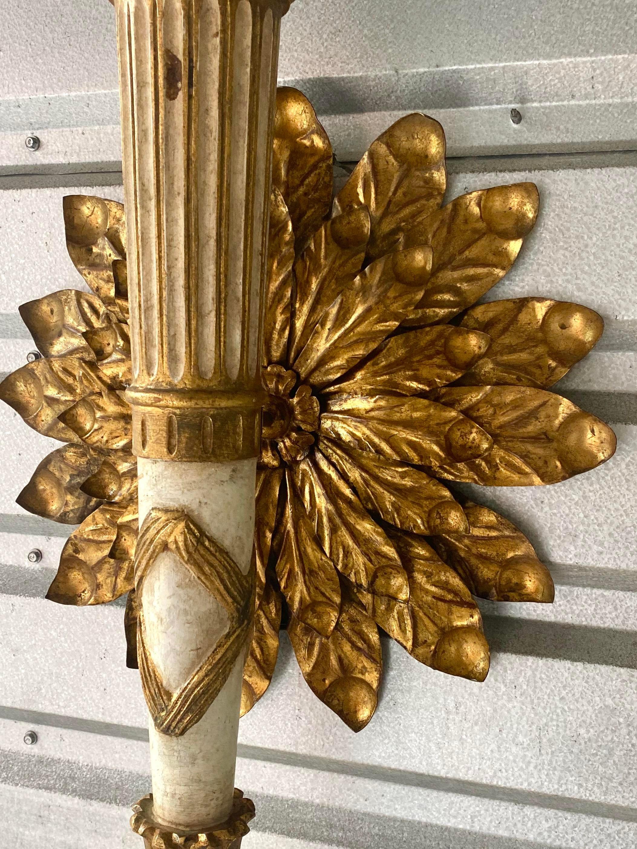 Incredible vintage gilt wall lamp. Done in the neoclassical style with gold finishes over gesso. Large wall mount gilt flower. Currently wired with a plug, but it easily converted to a wall mount. Acquired from a NY estate. 