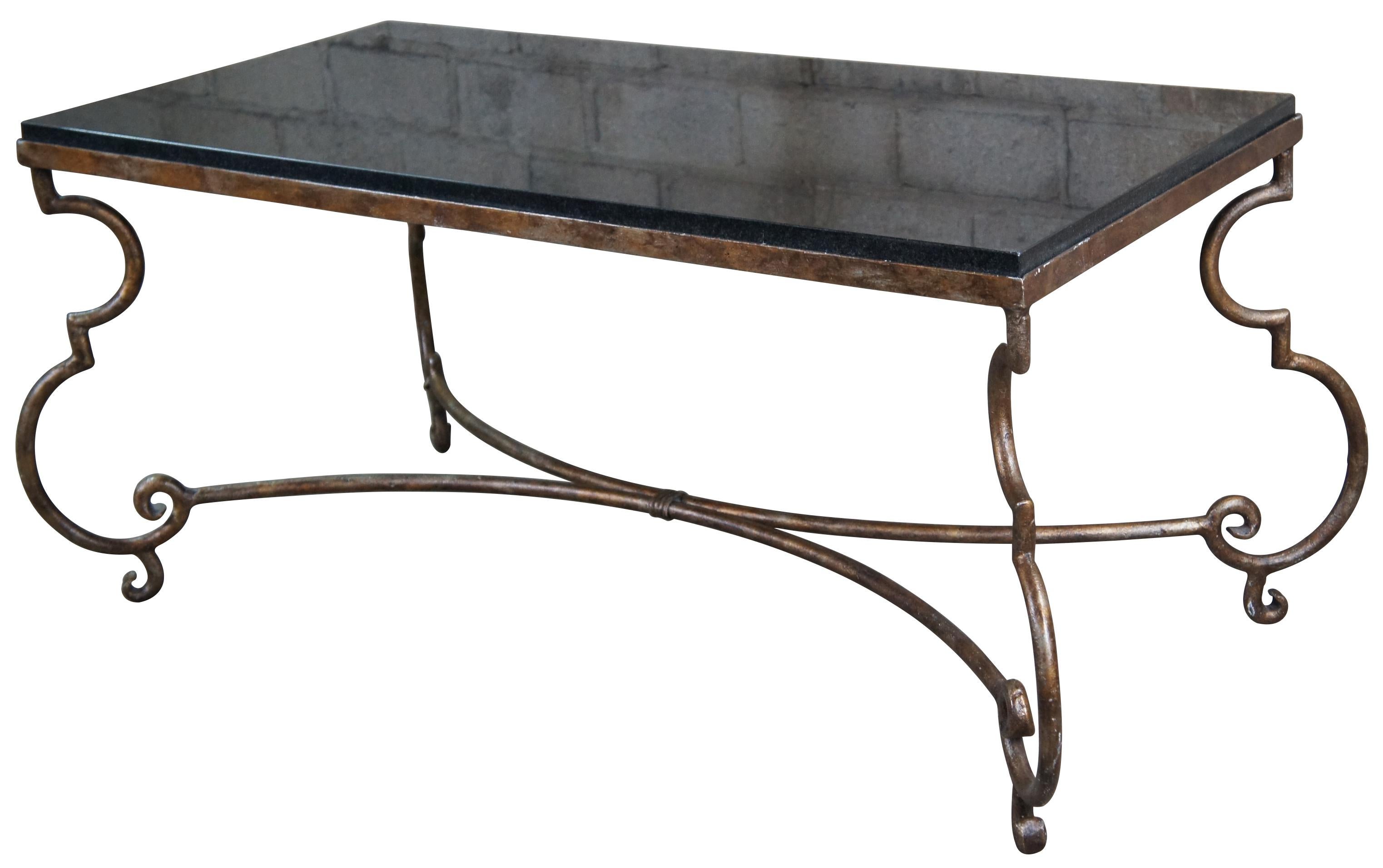 Vintage heavy rectangular coffee table featuring dark granite top and scrolled iron rustic gold painted base.

Measures: Top 43.25