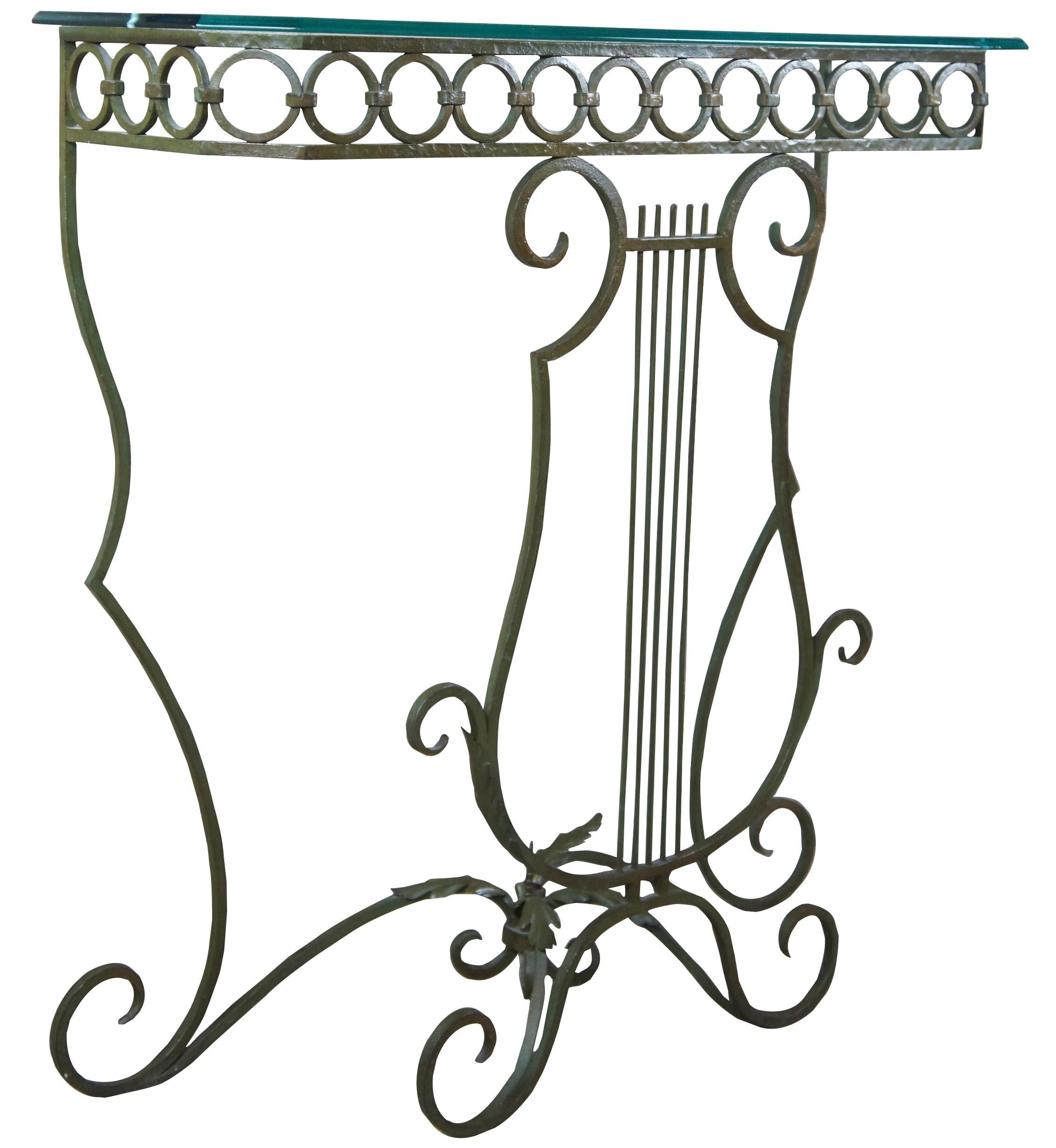 Late 20th century wrought iron with verdegris finish console table with glass top. Features s harpe front, scrolled feet and a ringed gallery and acanthus accents.
 