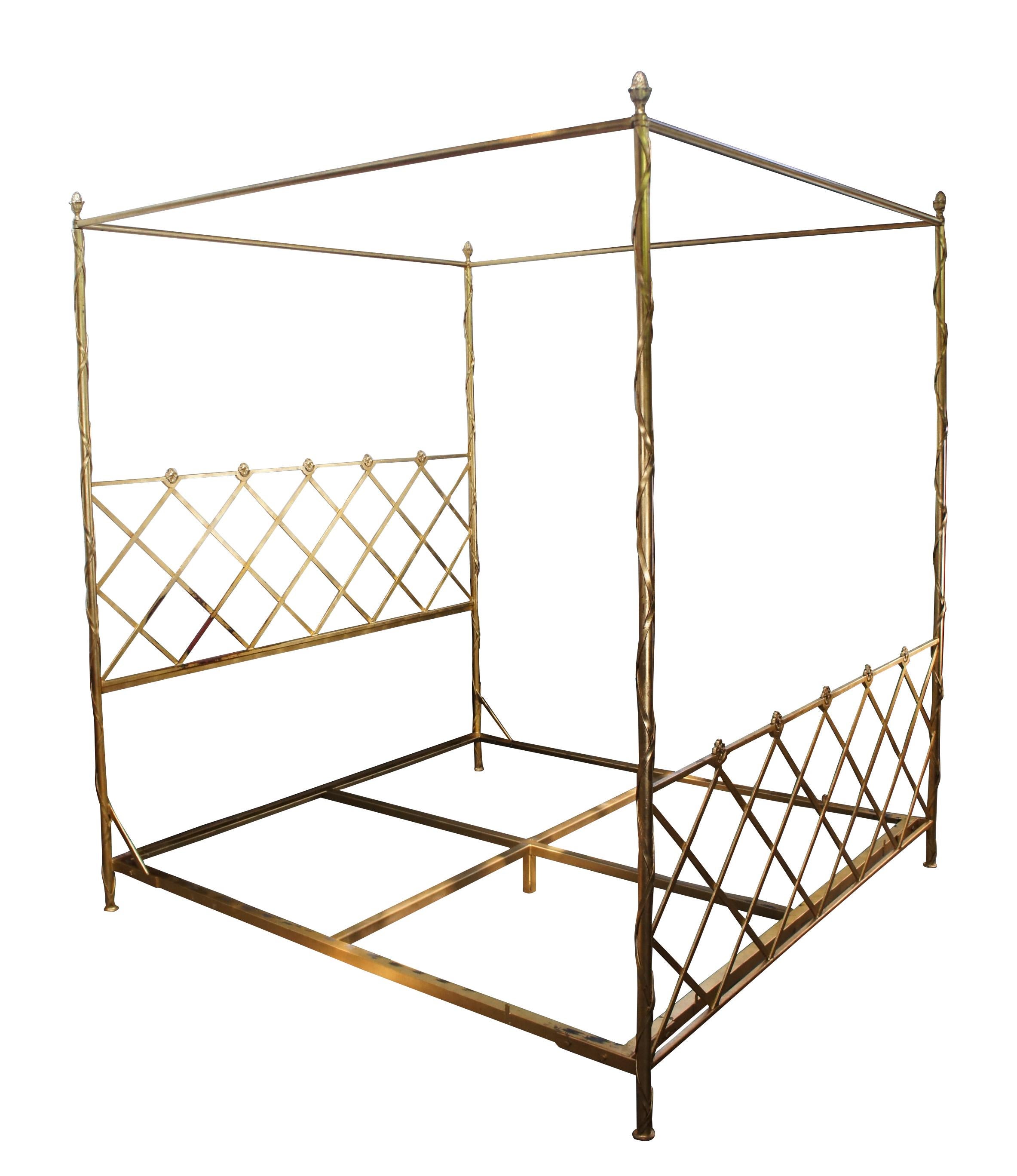 An impressive King size canopy bed.  Drawing inspiration from Italian and French styling. Made from iron with a golf leaf finish.  Features lattice medallion head and foot boards between neoclassical ribboned posts with acorn finials.  The Canopy or