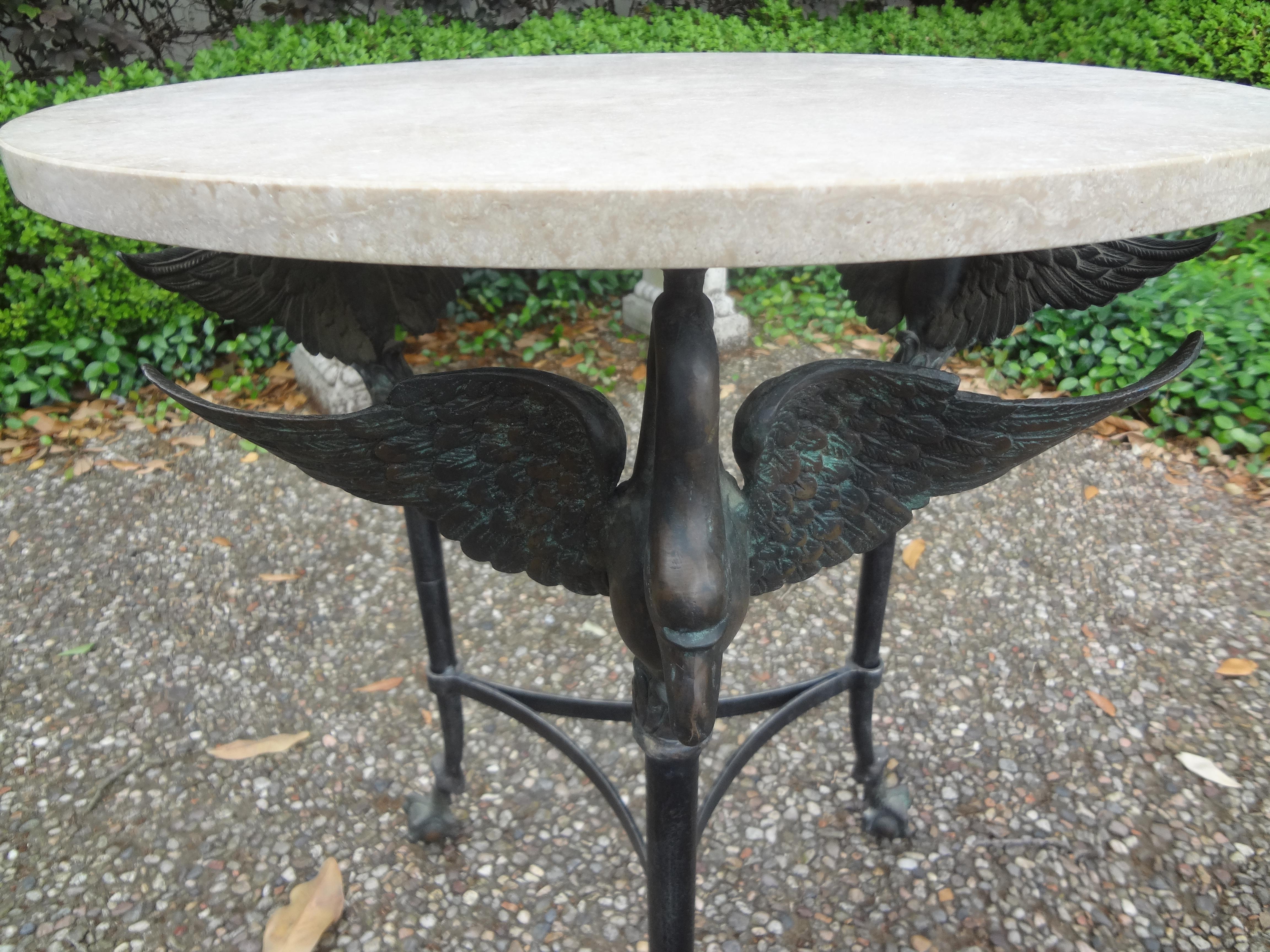 Vintage Neoclassical style bronze table with travertine top
Vintage Neoclassical style bronze table with travertine top. This stunning Empire style side table, drink table or gueridon is comprised of three swans with large talons clutching ball