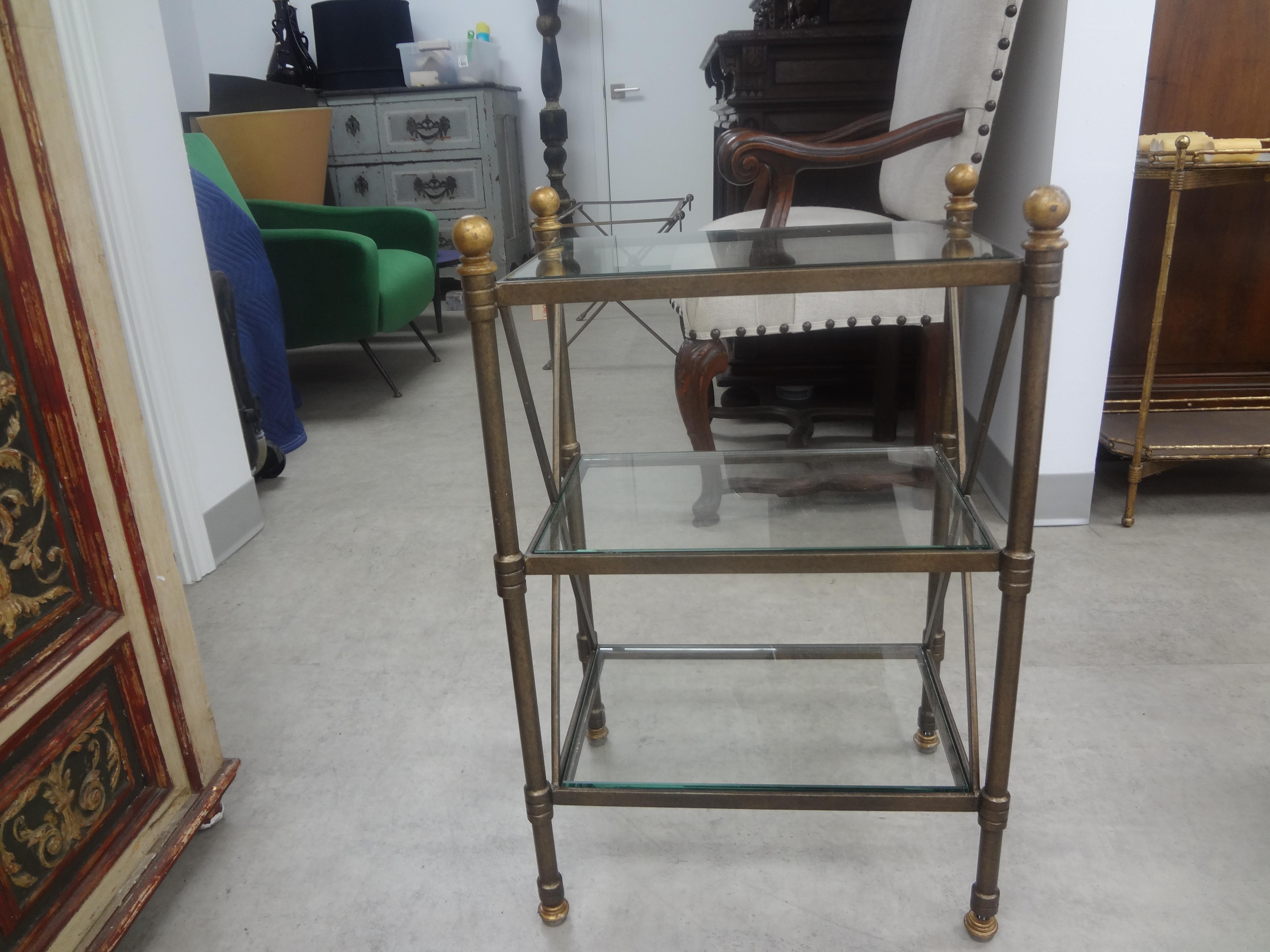 Vintage French Neoclassical Style Bronzed Iron Table.
This versatile Neoclassical style 3 tired heavy weight bronzed iron table with glass shelves is the perfect side table, end table, drink table,  gueridon or lamp table.